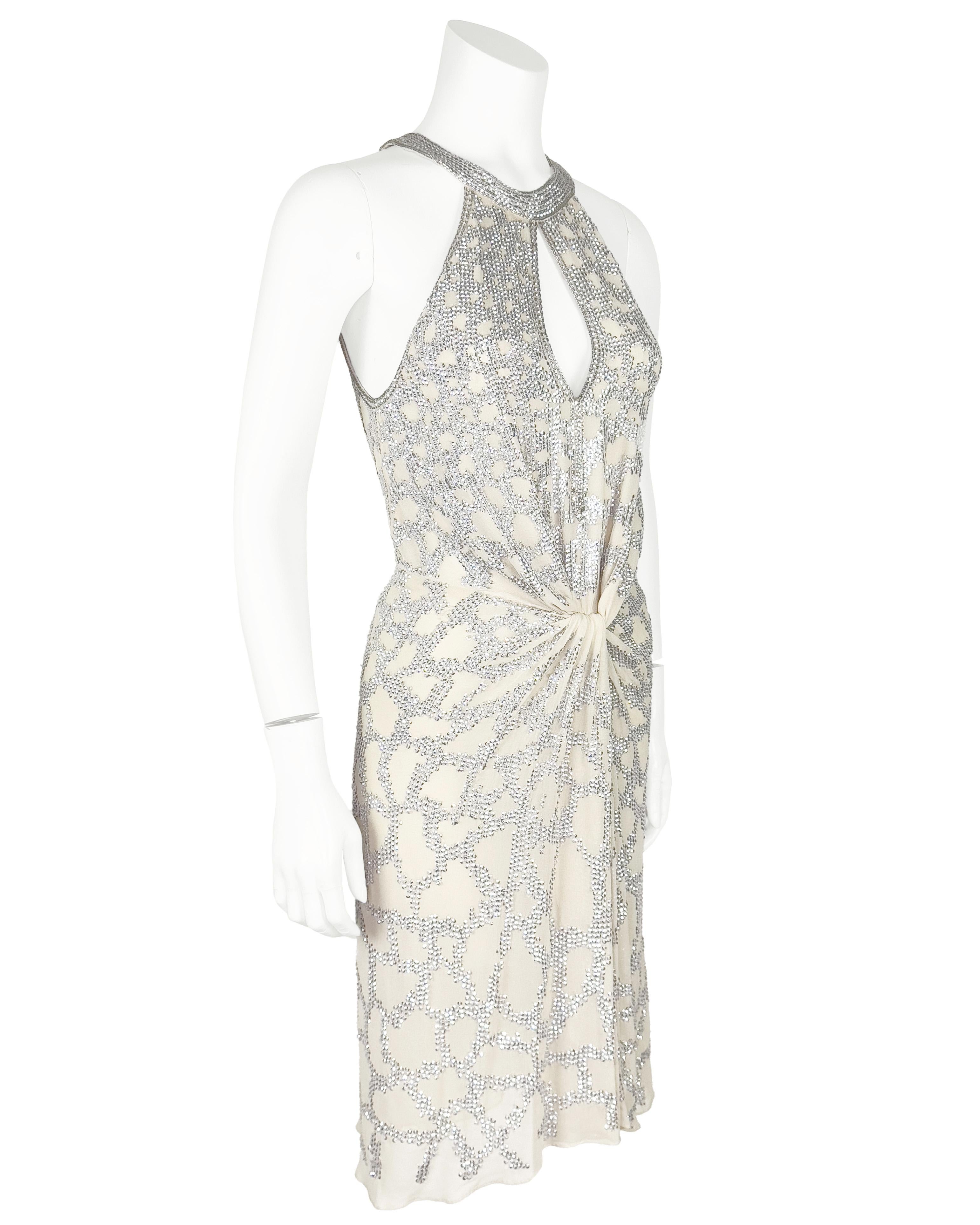 Stunning early 2000's Roberto Cavalli sexy open front mini evening dress encrusted with rhinestones. Deep front peep hole opening complimenting the halter style round neckline. Slight gathering centered below the waist appearing as an overlay. The