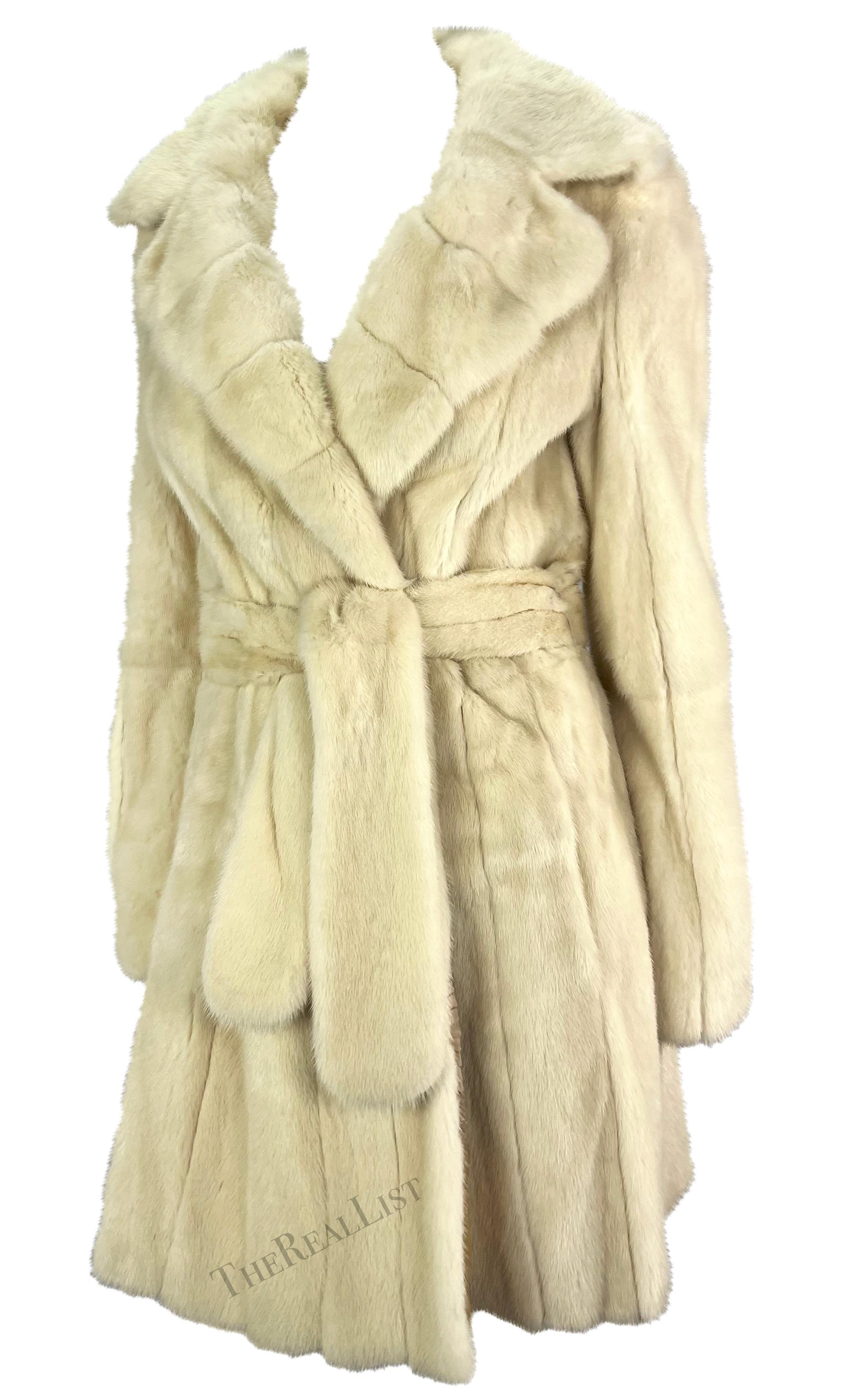 Presenting a stunning creme Roberto Cavalli mink coat. From the 2000s, this luxurious coat is constructed entirely of ultra-soft mink fur. This chic wrap coat features a large fold-over collar and is made complete with the matching tie belt.