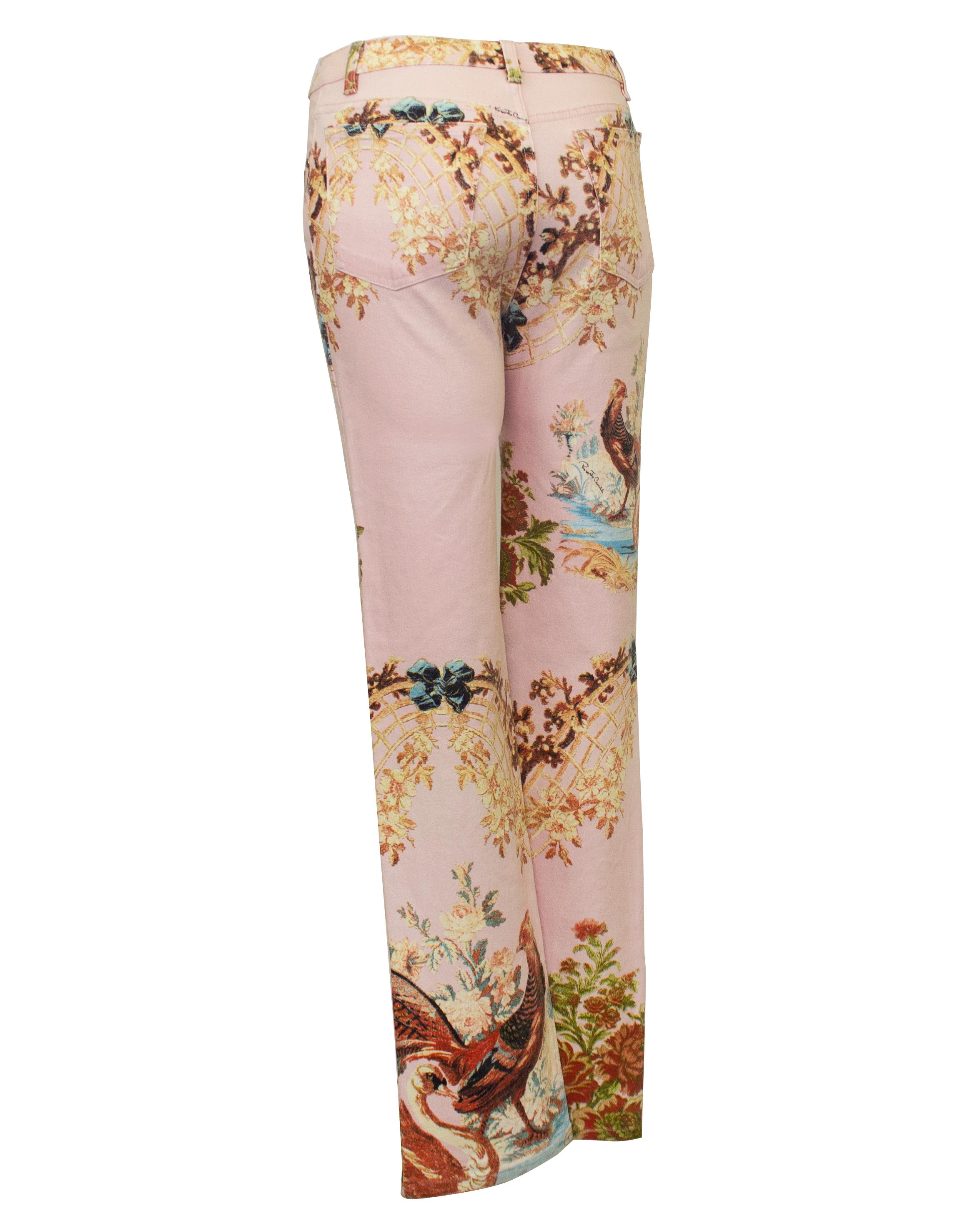 Roberto Cavalli printed five pocket jeans from S/S 2003. Pale pink with a beautiful Chinoiserie inspired print featuring florals, bows, lattice, pheasants and swans. Mid rise with flared leg. Many different elements of the print are highlighted with