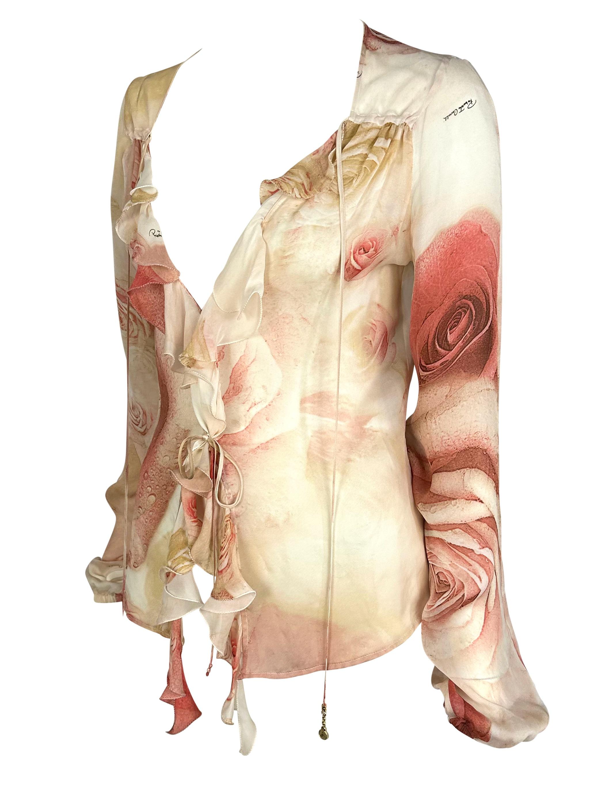 TheRealList presents: a beautiful sheer pink Roberto Cavalli floral top. Step into the fashionable realm of the 2000s with this sheer top featuring a bold rose print throughout. Its captivating design draws attention with its vibrant floral motif.