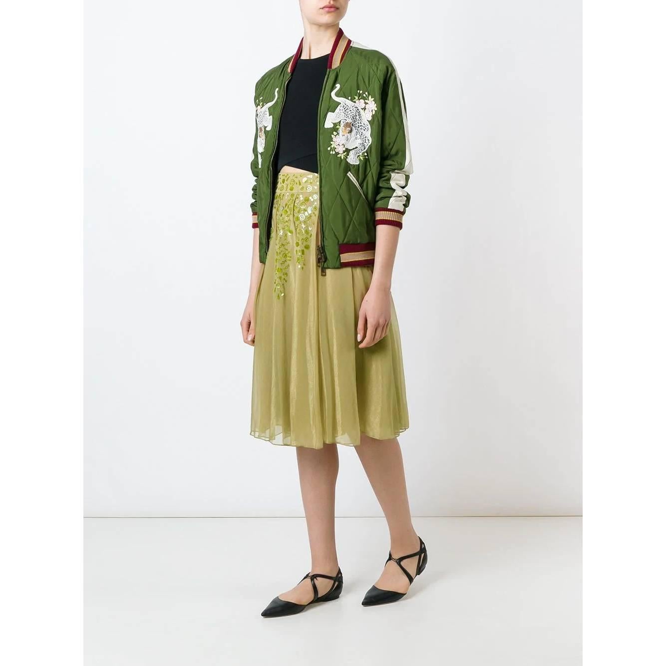 A.N.G.E.L.O. Vintage - ITALY
Romeo Gigli ocher green skirt with a layered design. Model with high waist and pleats at the waist that give movement. Decorative PVC applications and back closure.

The product has some missing applications as shown in
