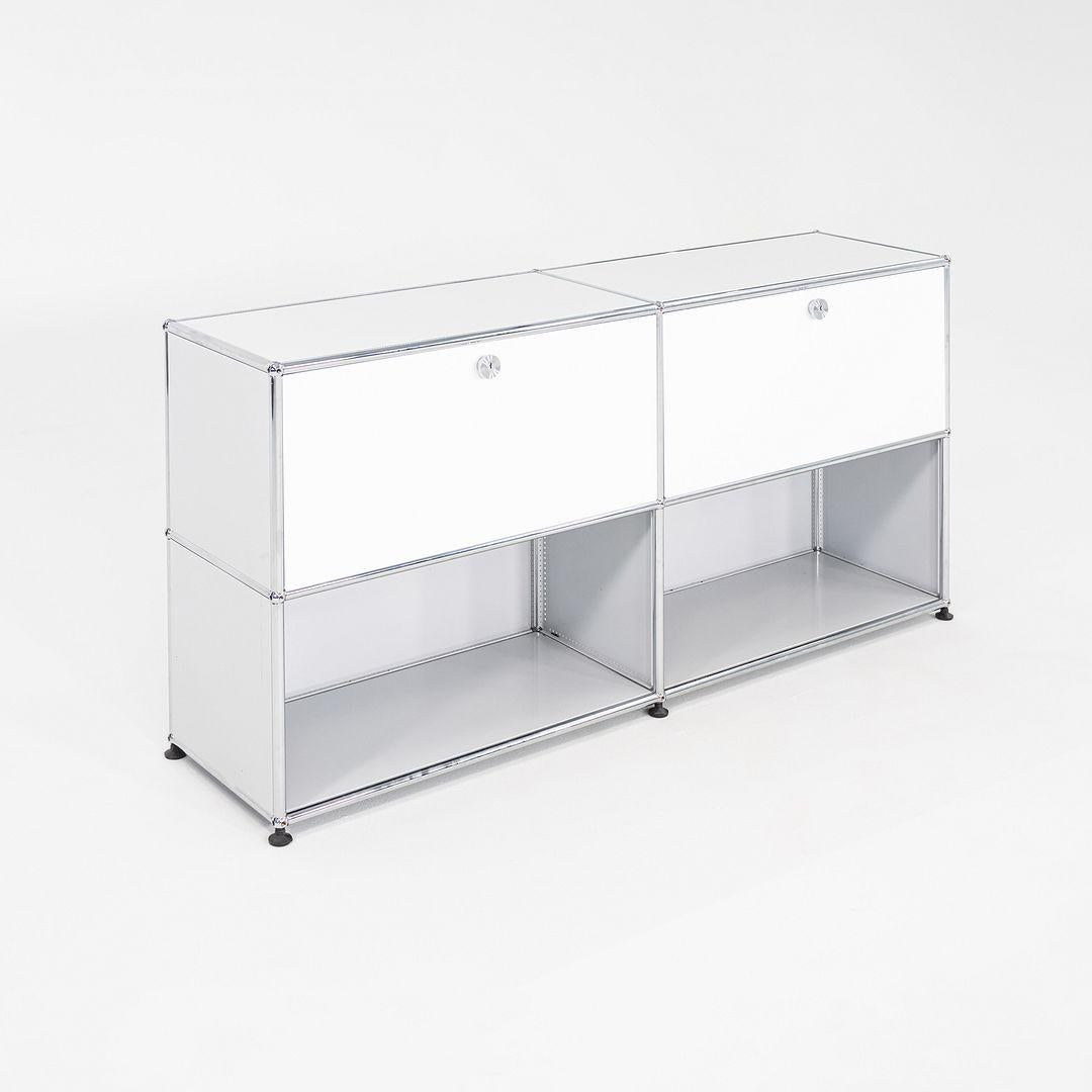 This is a USM Haller C2A Credenza, originally designed by Fritz Haller and Paul Schaerer in 1963. This particular example was produced by USM in Switzerland in the 2000s. The credenza is made up of powder coated steel panels and a chromed steel