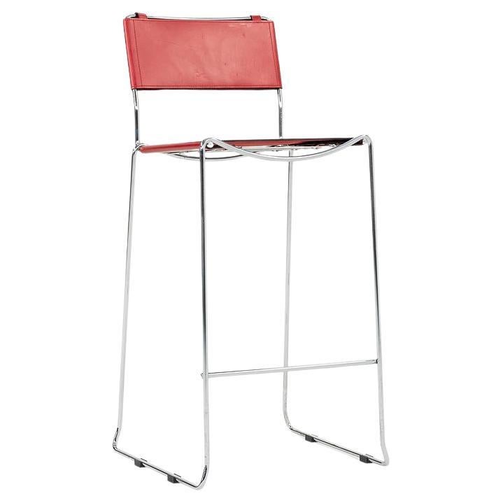 This is a set of four stacking bar stools, designed by Giandomenico Belotti. These particular examples were produced by Alias in Italy in the 2000s. The stools are comprised of a chrome base and red leather seats. The listed price includes all four