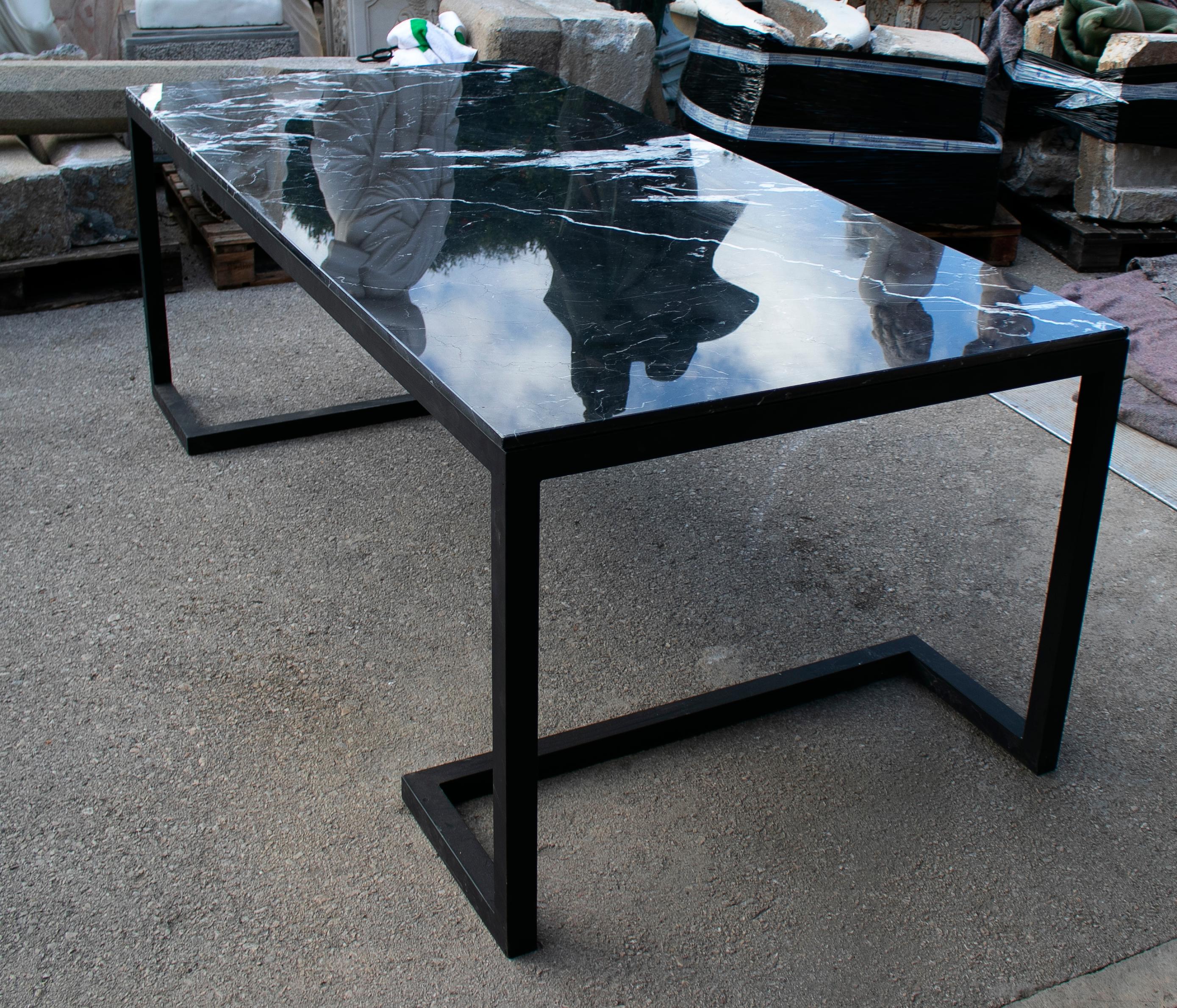 2000s Spanish iron table with Marquina black marble top.
