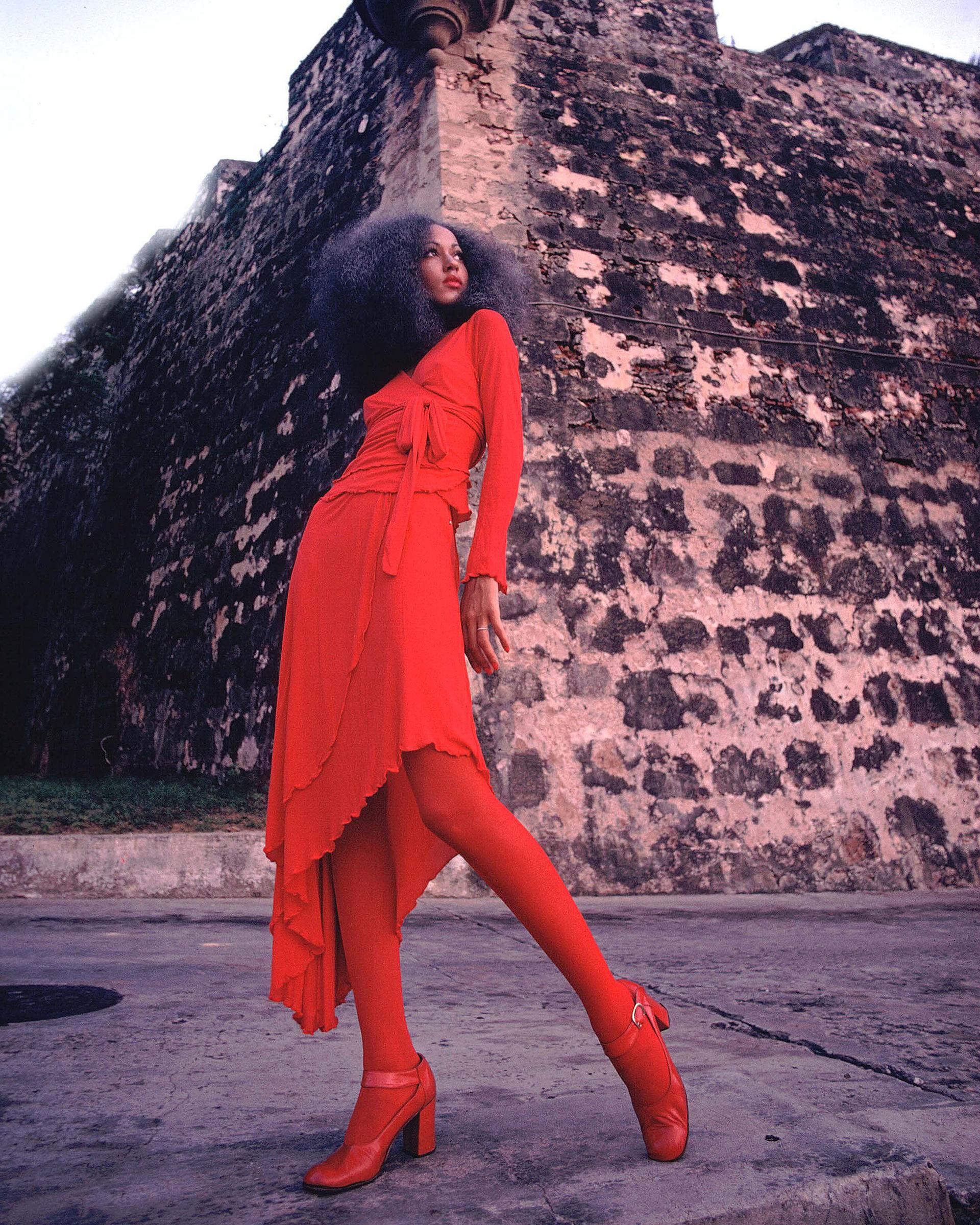 Early 2000's Stephen Burrows' World red halter wrap gown with lettuce ruffle layered trim - re-issue of original 1970's design. Features wrap ties at high waist and signature Stephen Burrows red zig-zag stitching throughout. This style of hem was