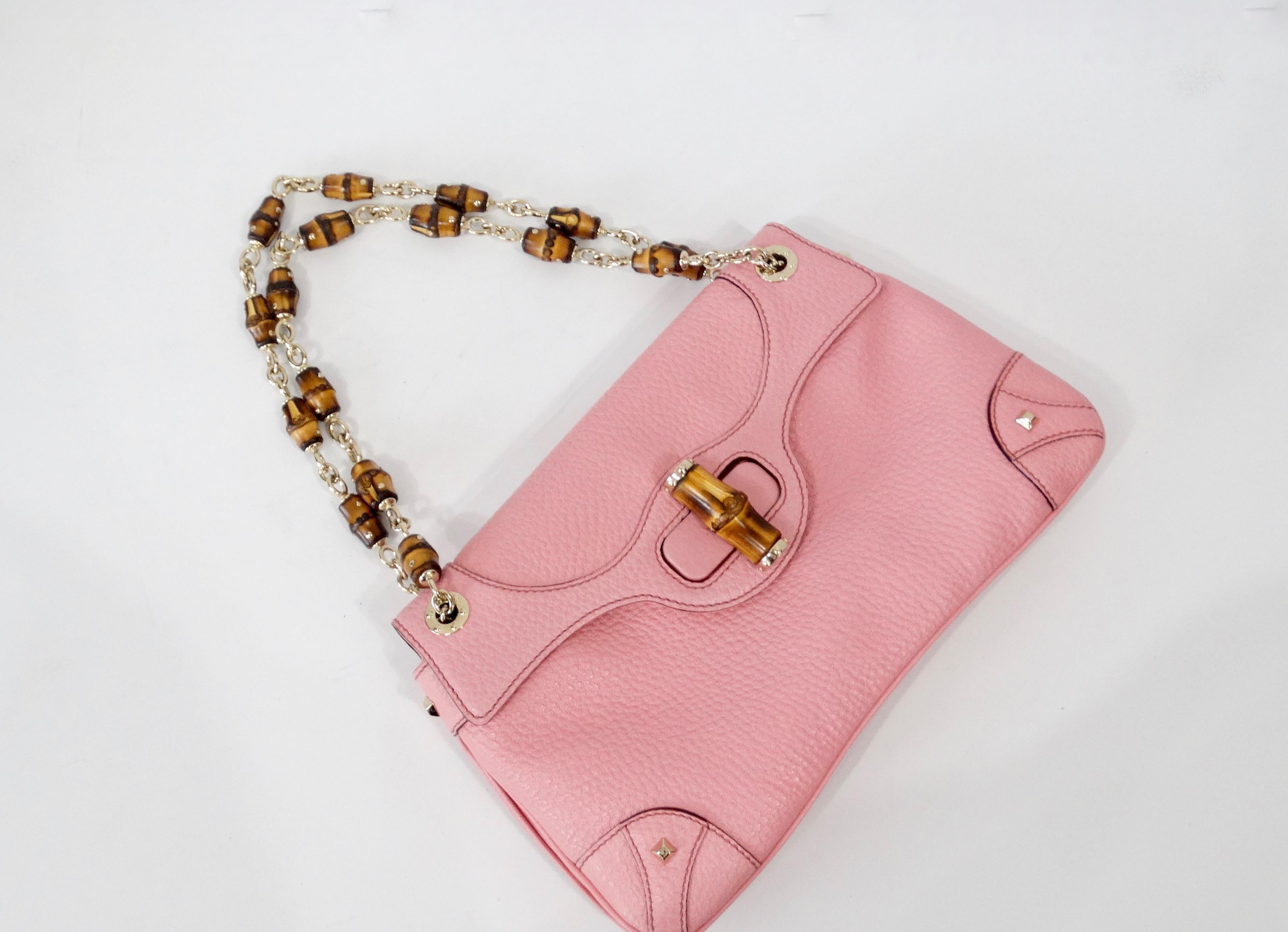 Always be ready for a getaway with this adorable Tom Ford for Gucci shoulder bag! Circa early 2000s, this light pink pebbled leather bag features gold-tone hardware, dual shoulder straps with chain link bamboo accents, and leather crafted detailing.