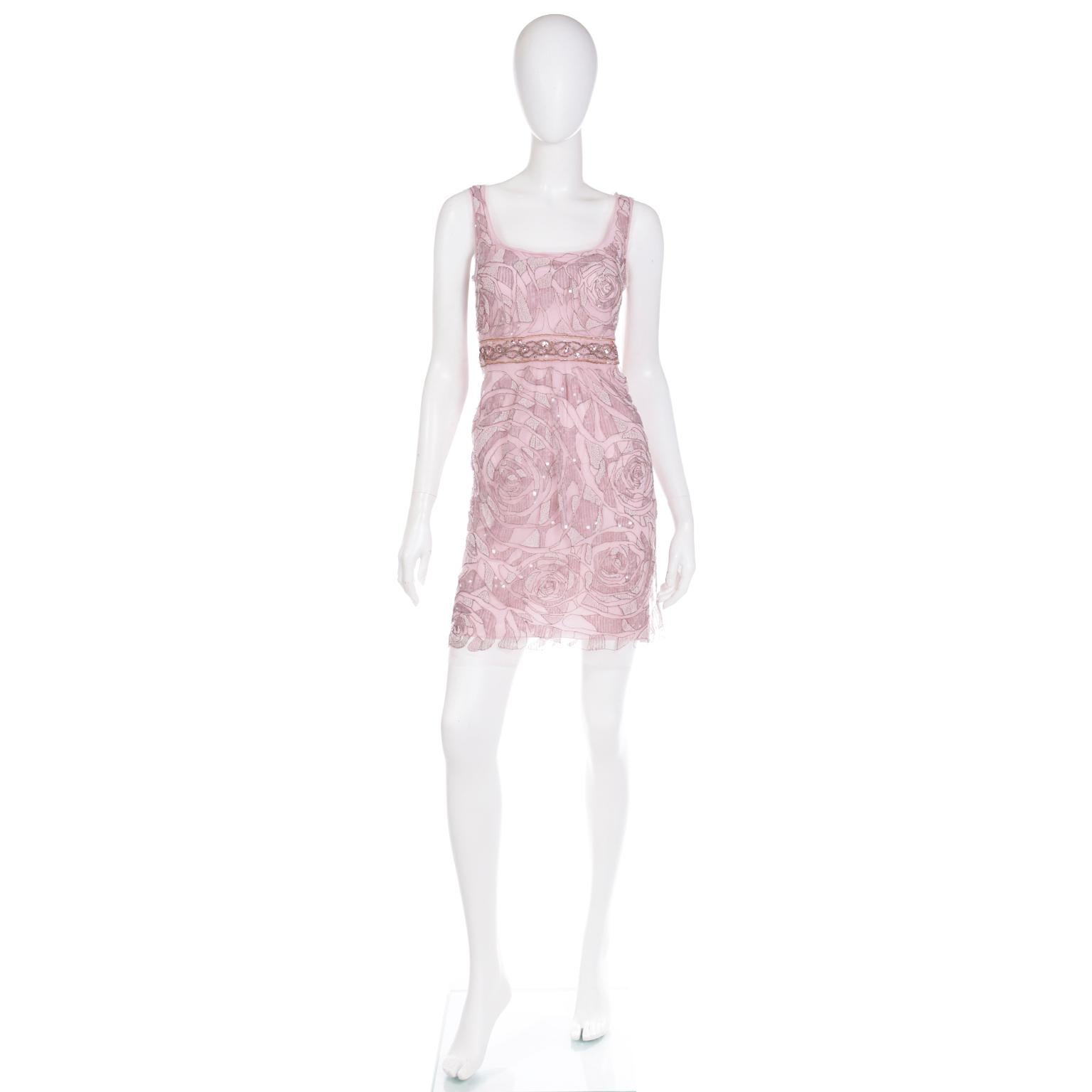This pretty vintage Emanuel Ungaro beaded evening dress has a 100% silk pink under dress and a delicate nylon net overlay that is perfectly embellished with metallic embroidery, beads and iridescent sequins. The embroidery and beads form giant