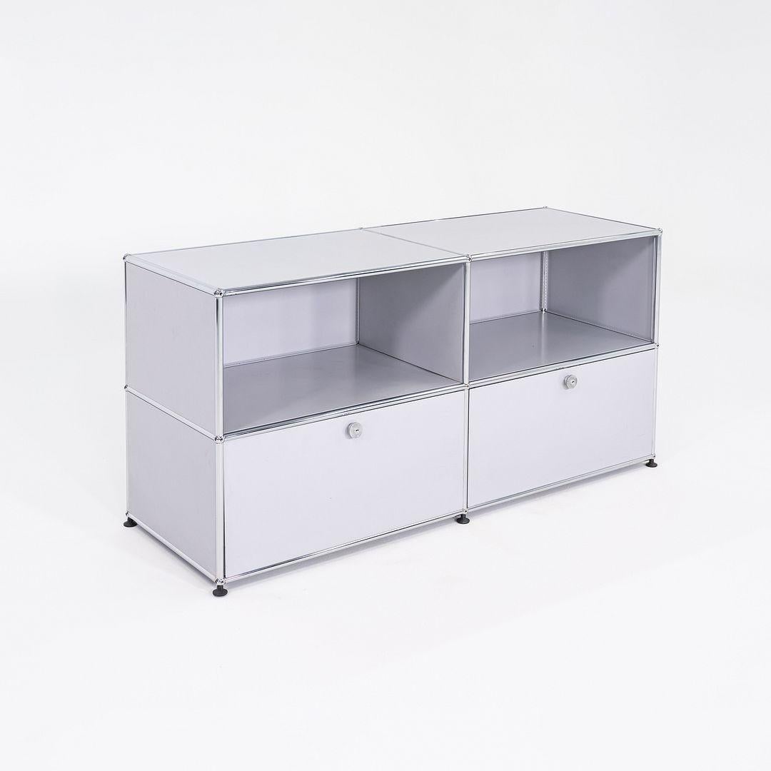This is a USM Haller C2A Credenza, originally designed by Fritz Haller and Paul Schaerer in 1963. This particular example was produced by USM in Switzerland in the 2000s. The credenza is made up of powder coated steel panels and a chromed steel