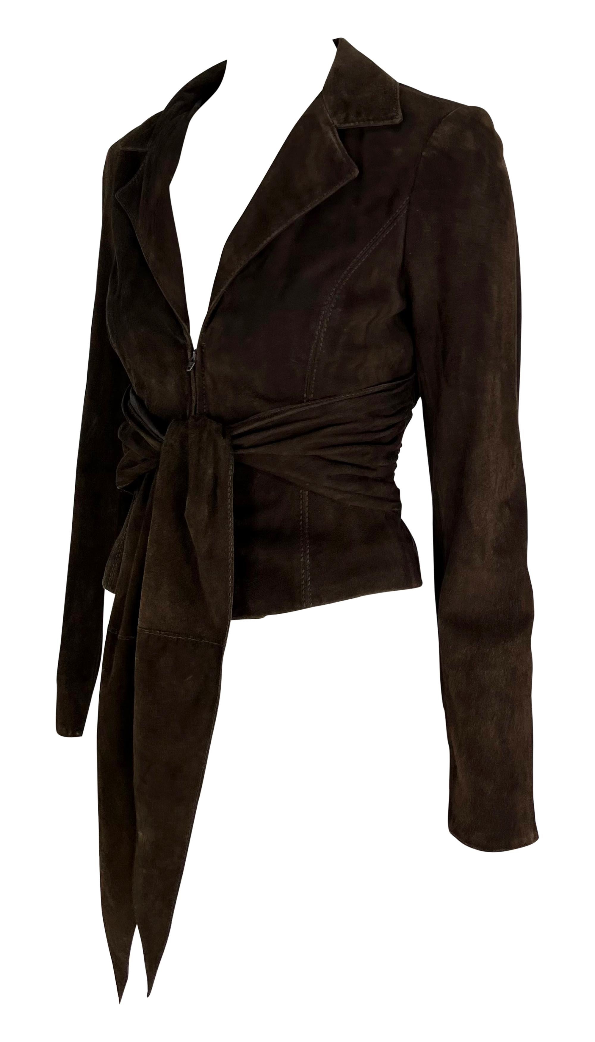 From the early 2000s, this brown Valentino jacket is constructed entirely of suede. The jacket features a notch lapel, plunging neckline, and a built-in tie at the waist. This luxurious Valentino jacket is the perfect versatile wardrobe addition.