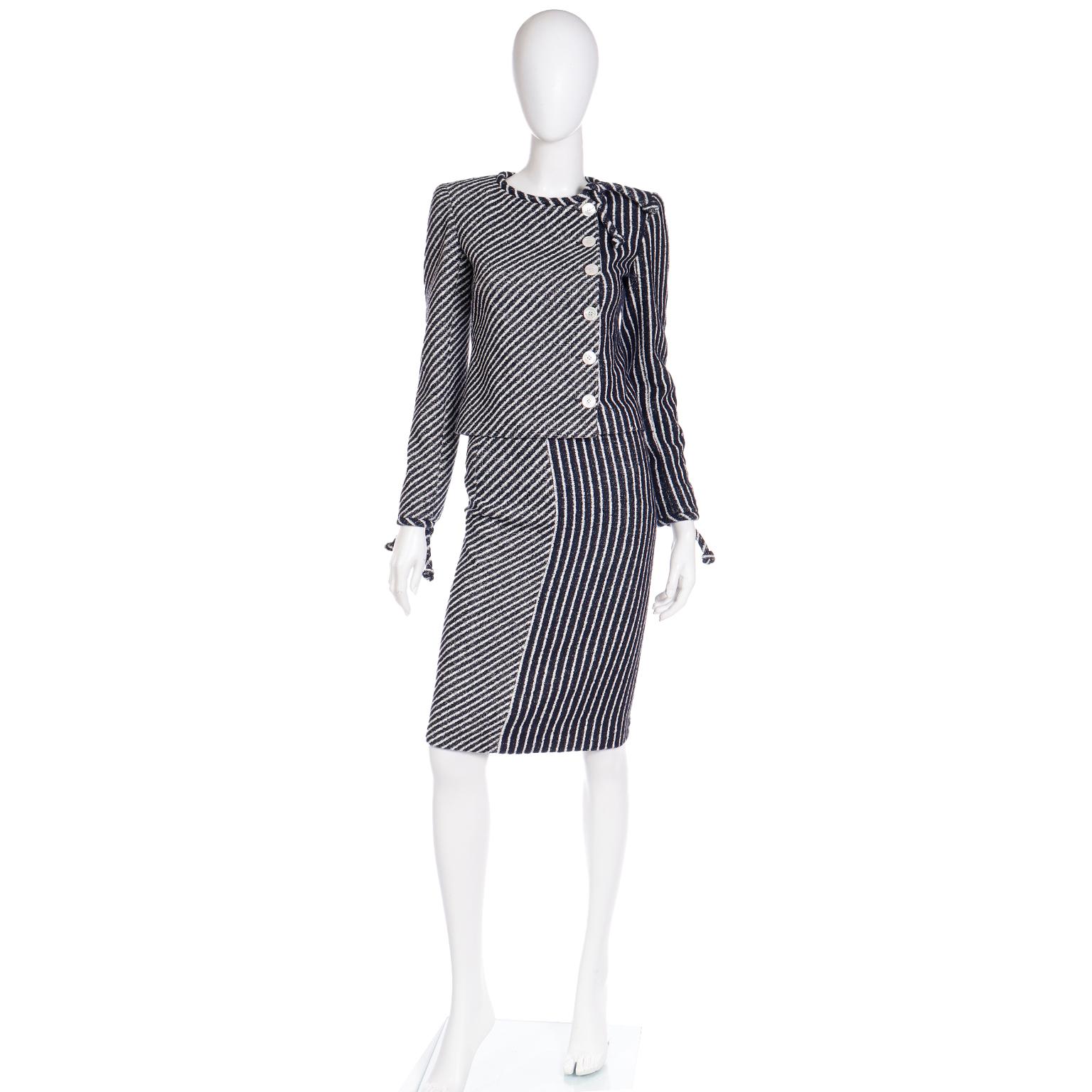 We think this 2 piece Valentino ensemble is the perfect, stylish summer suit! This outfit includes a Jacket and a Skirt in a navy blue and white striped textured woven fabric.. The collarless jacket has shoulder pads for structure, a tie at the