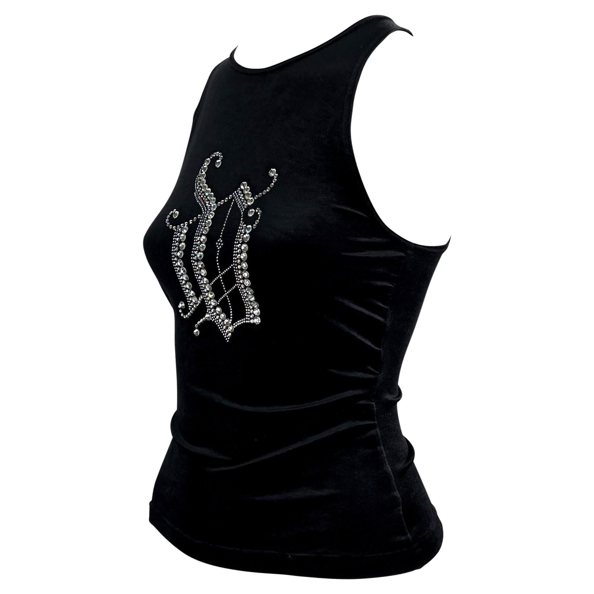 Presenting a black velvet stretch top designed by Donatella Versace in the early 2000s. The bust of the tank is embellished with clear crystal rhinestones in varied sizes arranged in an oversized 'DV' monogram. A Y2K dream, this tank is sure to