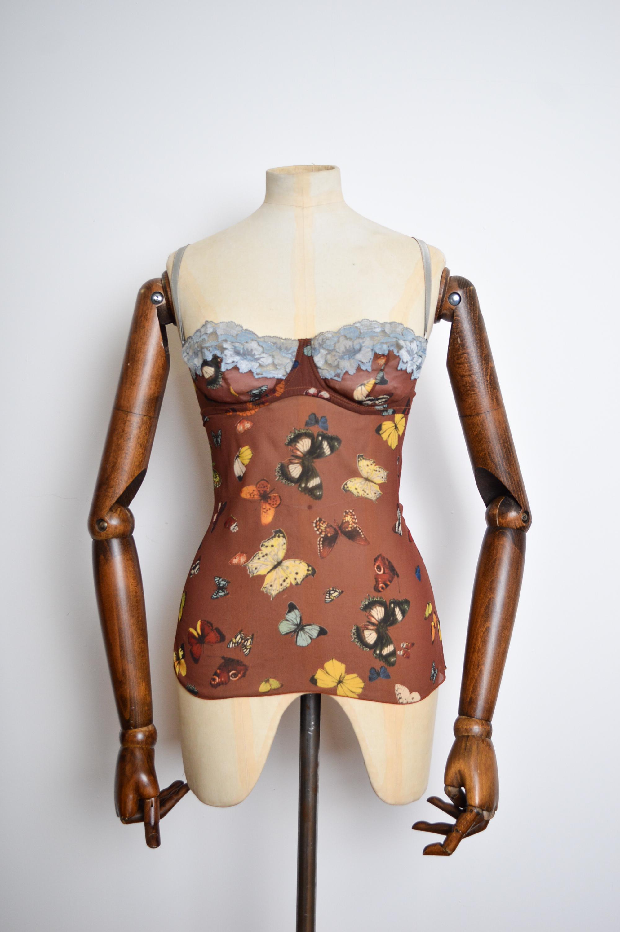2000's Vintage Silk Butterfly patterned Corset designed by DOLCE & GABBANA.   

MADE IN ITALY.   

This beautiful bustier is crafted from a sheer brown silk with a dusty blue lace trim.   

79% Silk
7% Elasthane
14% Polyamide 
(Stretchy) 