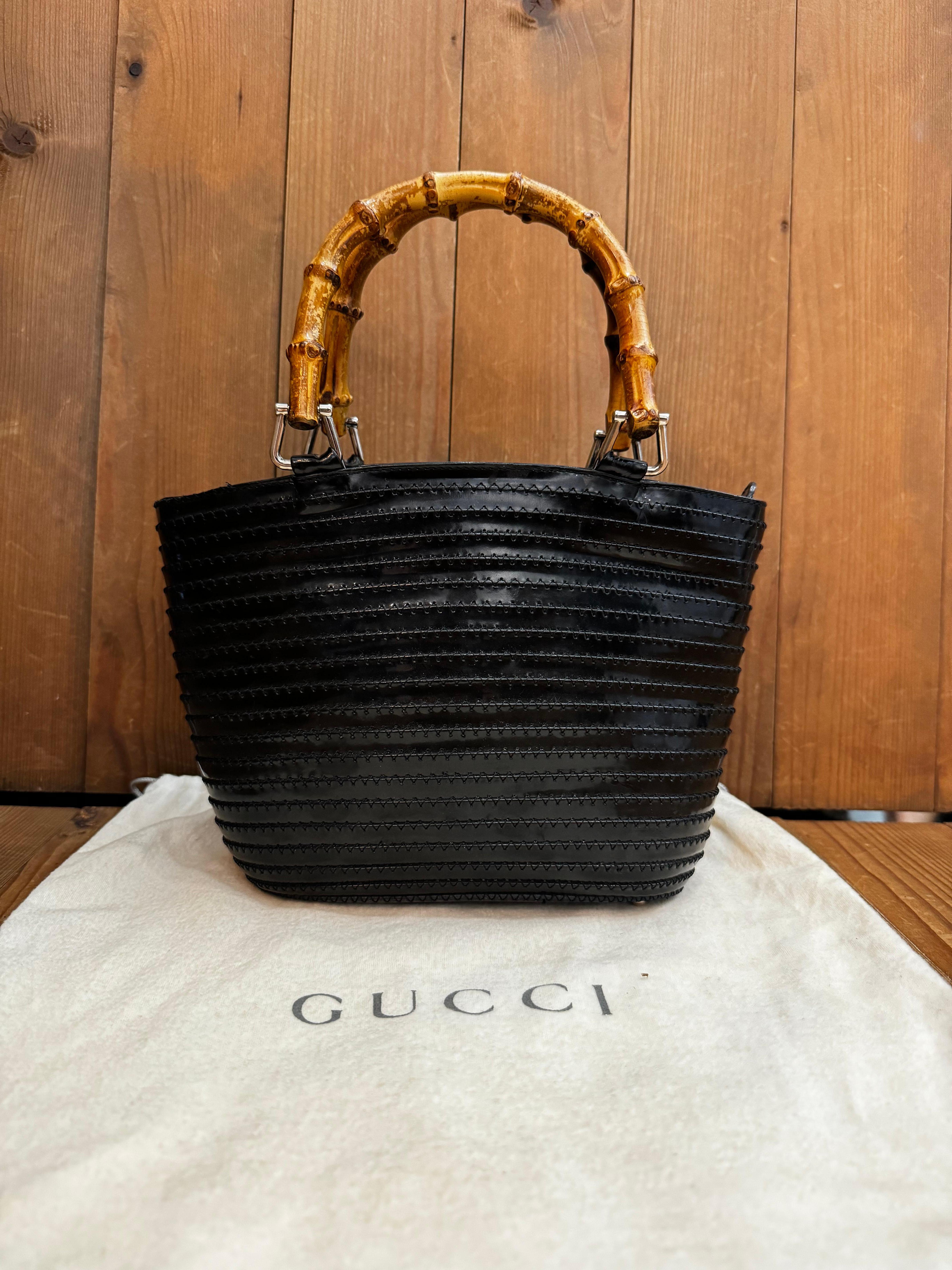 This vintage GUCCI mini tote bag is crafted of black smooth leather in folds featuring silver toned hardware and bamboo handles. Top zipper closure opens to a black leather interior featuring a zippered pocket. Made in Italy. Measures approximately