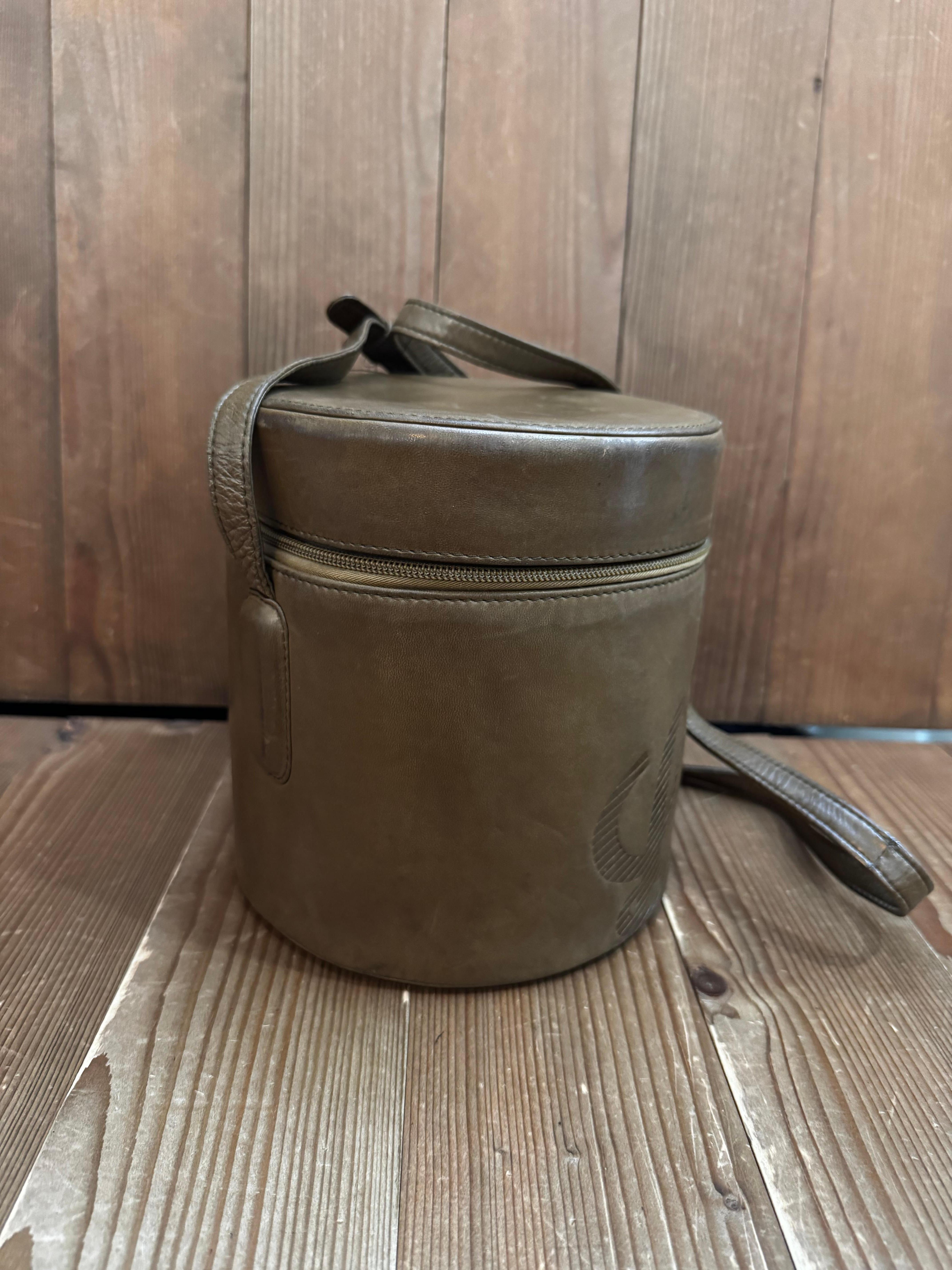 This vintage LOEWE Anagram bucket crossbody bag is crafted of soft calfskin leather in brown featuring an adjustable shoulder strap. Top zipper closure opens to a coated interior in black. Made in Spain. Measures approximately 6.5 x 6.5 x 7 inches