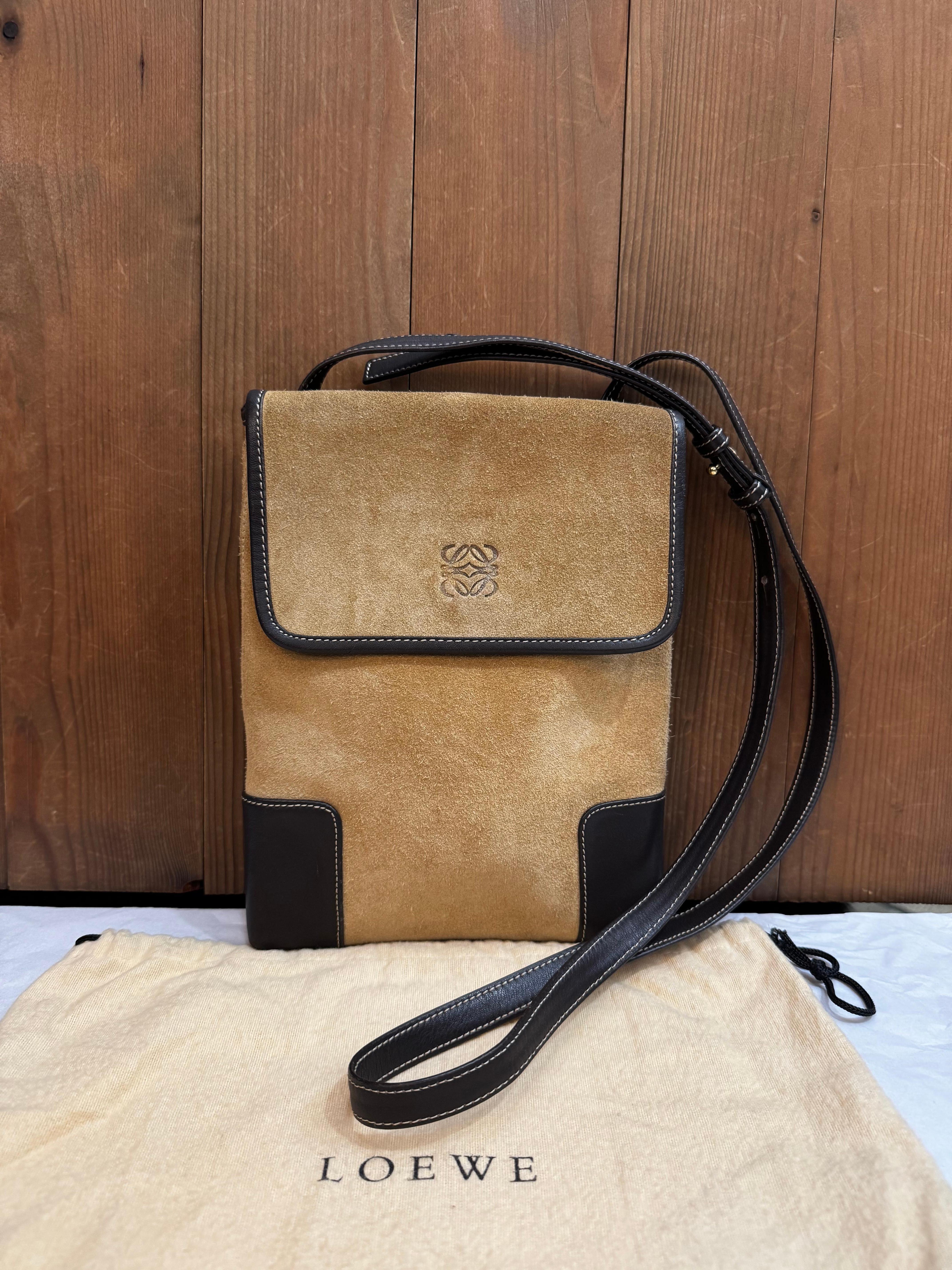 This vintage LOEWE Anagram crossbody bag is crafted of brown calfskin suede and leather featuring a back slip pocket. Front flap magnetic snap closure opens to an unlined interior of smooth calfskin leather. Made in Spain. Measures approximately 9.5