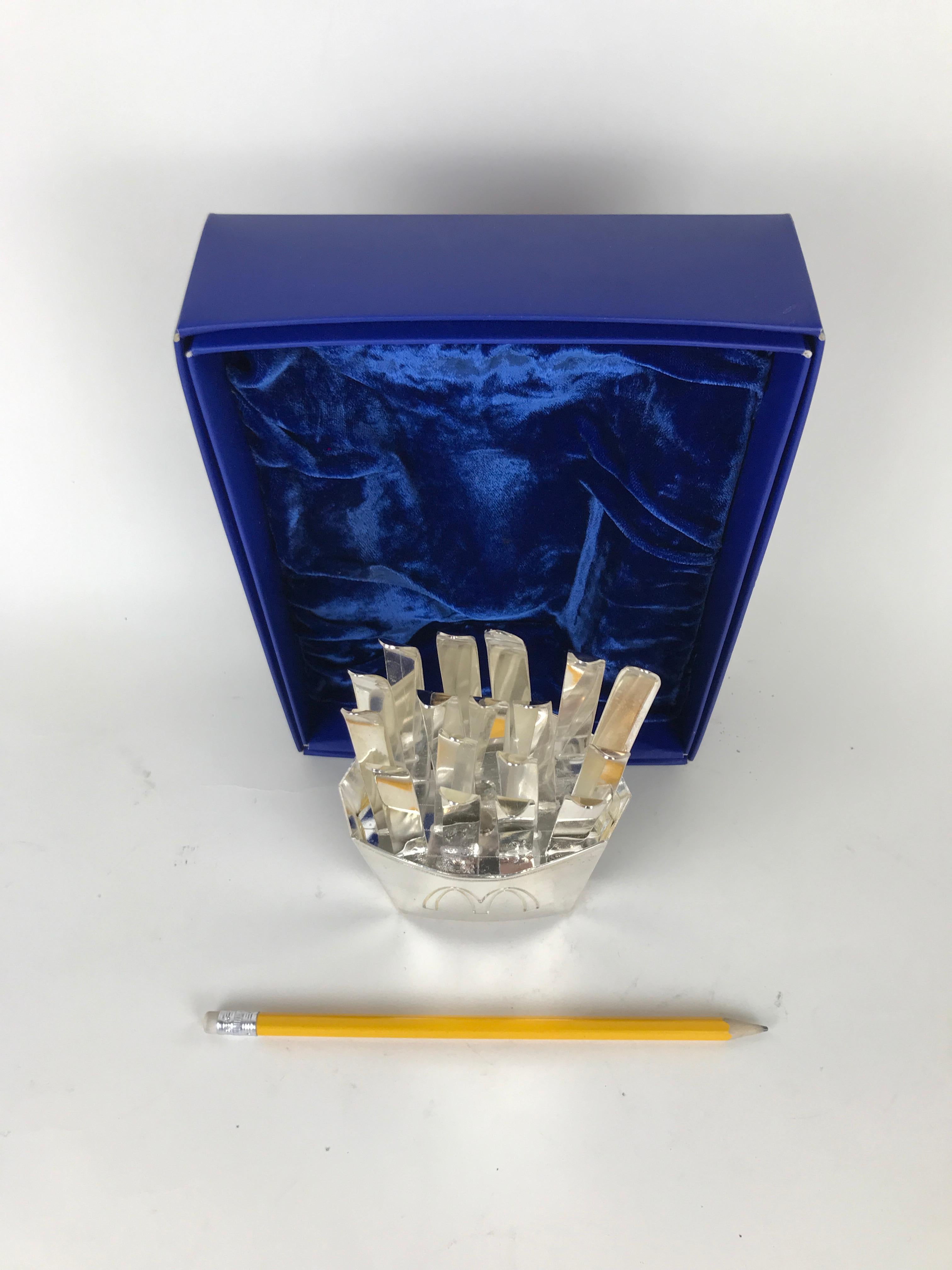Highly collectible vintage McDonald's celebratory souvenir of the XX Olympic Winter Games held in Turin, Italy in 2006.

The souvenir is in the shape of the french fries McDonald's box but realized in bress silver plated with multiples skis