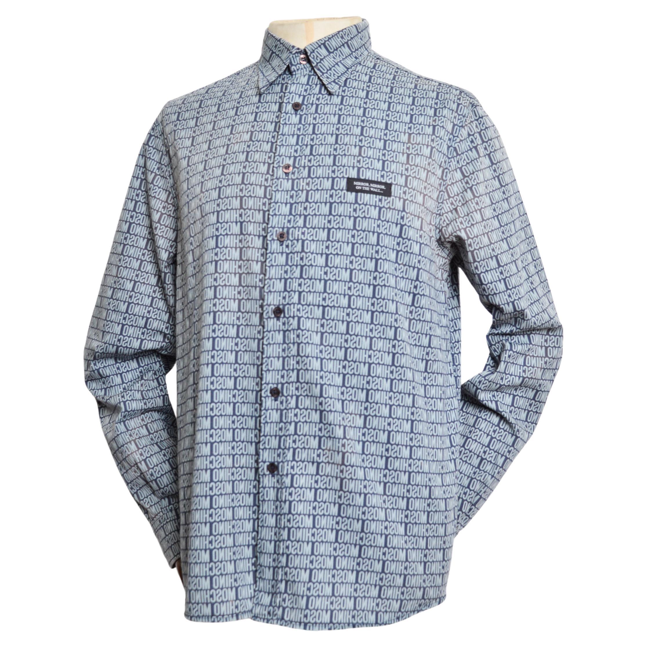 Early 2000's UK Garage Era 'MOSCHINO' repeat pattern Long sleeve Shirt, crafted from a printed cotton in Pale blue & Mid blue shades.

MADE IN ITALY.   

Features: Reverse mirror effect print, button down front , Collar, Long sleeves, cuffs,