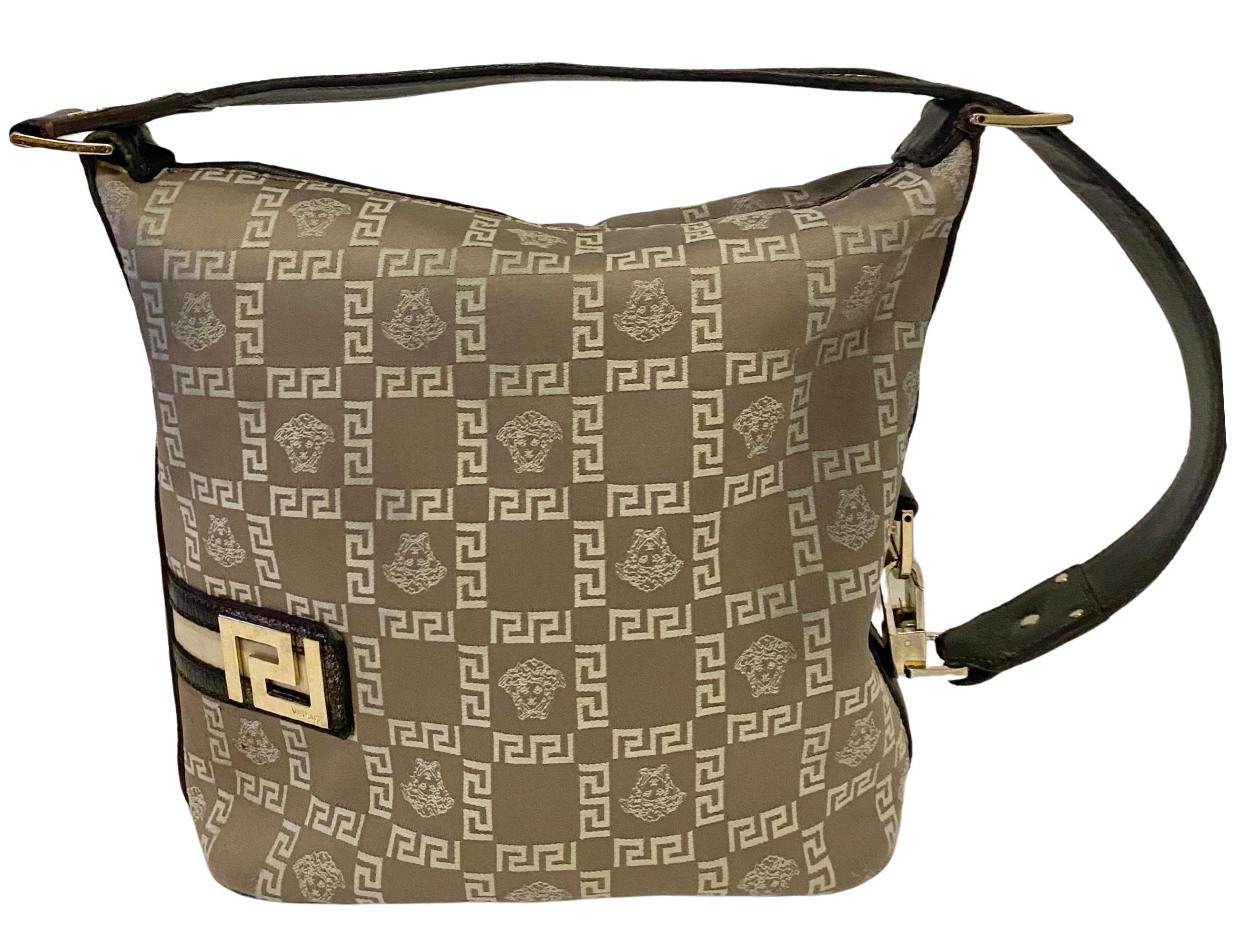 Pre-Donatella era VERSACE Medusa Jacquard Leather Greca Vintage Hobo Shoulder Bag,  made in Italy. Dating from the early 2000s, the bag features the iconic Medusa and Greca jacquard pattern in a luxurious Neutral Beige 
Black colorway, paired