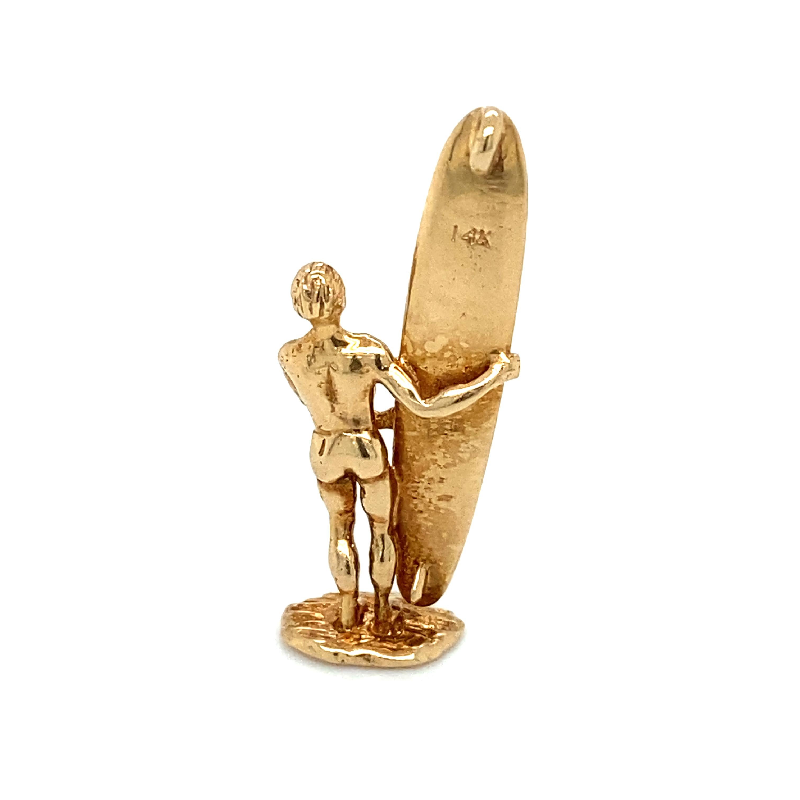 Item Details: This whimsical travel souvenir from Waikiki Beach in Hawaii features a surfer with his surfboard. Crafted in 14 karat yellow gold, it makes a wonderful charm or pendant.

Circa: 2000s
Metal Type: 14 Karat Gold
Weight: 3.0 grams
Size: