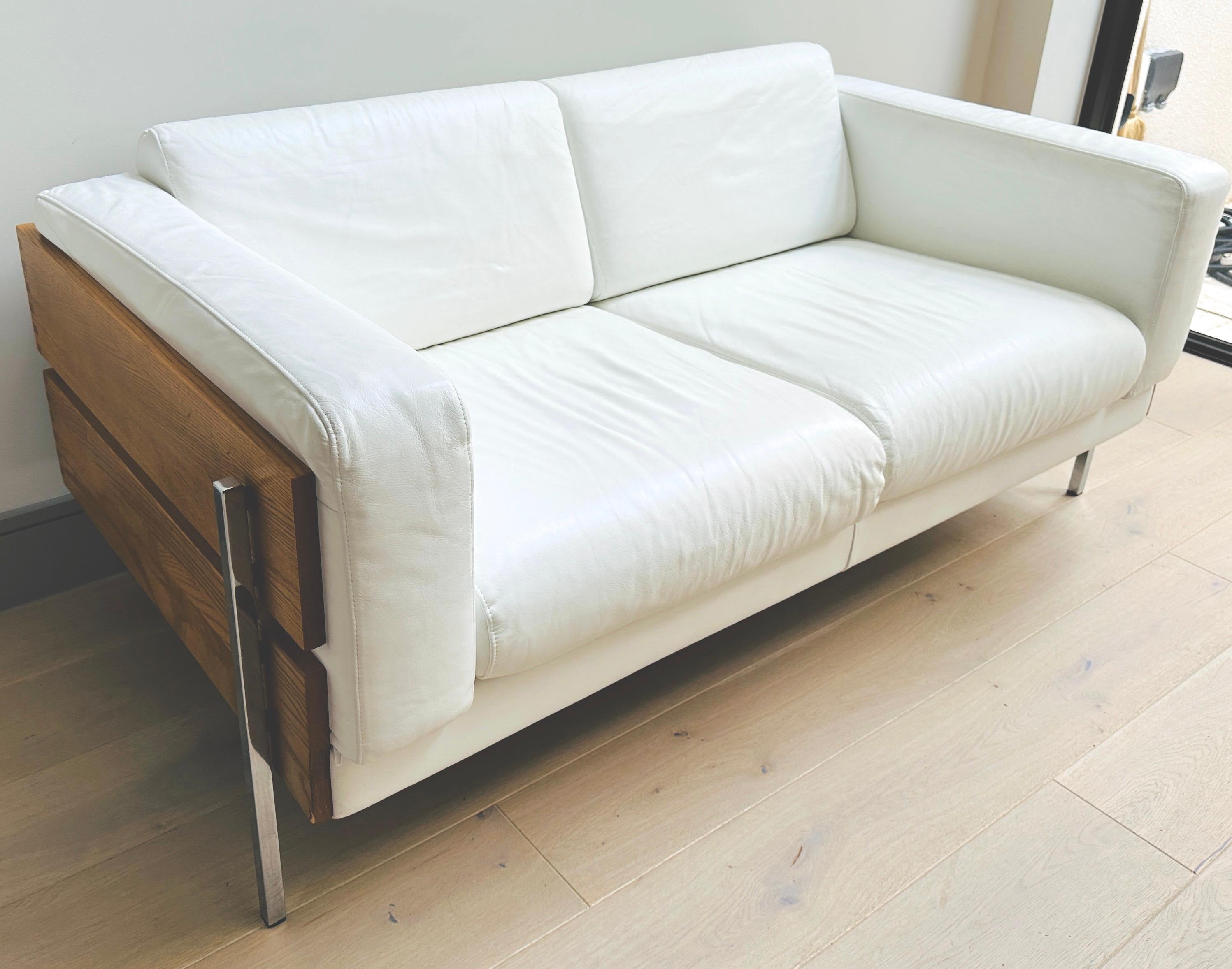 A classic and iconic 'Forum II' two-seater sofa designed by Robin Day for Hille. Originally designed in 1964 and later licensed and manufactured by Habitat in the early 2000s.  

This version in soft and supple white leather with feature stitching