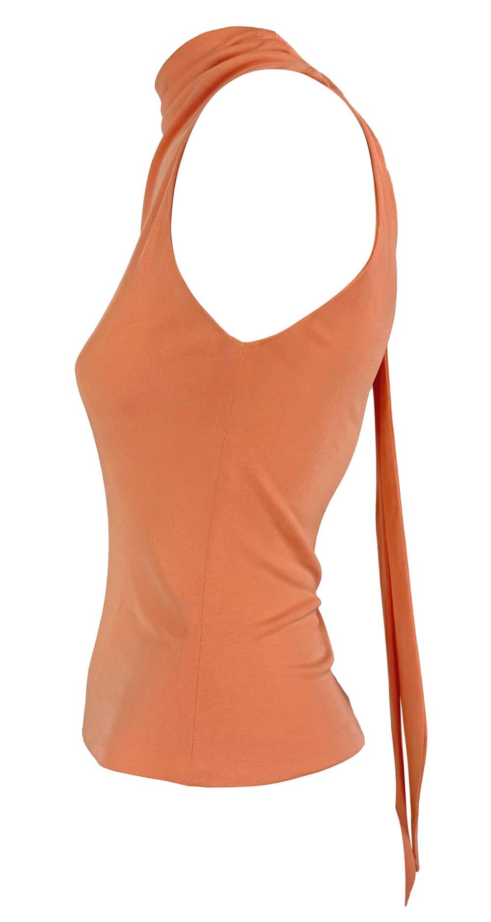 This early 2000s Yigal Azrouël light orange top is crafted from soft, stretchy fabric. It features a draped necktie detail at the back and minimal sleeveless silhouette.

Approximate measurements:
Size - US3
Bust: 28