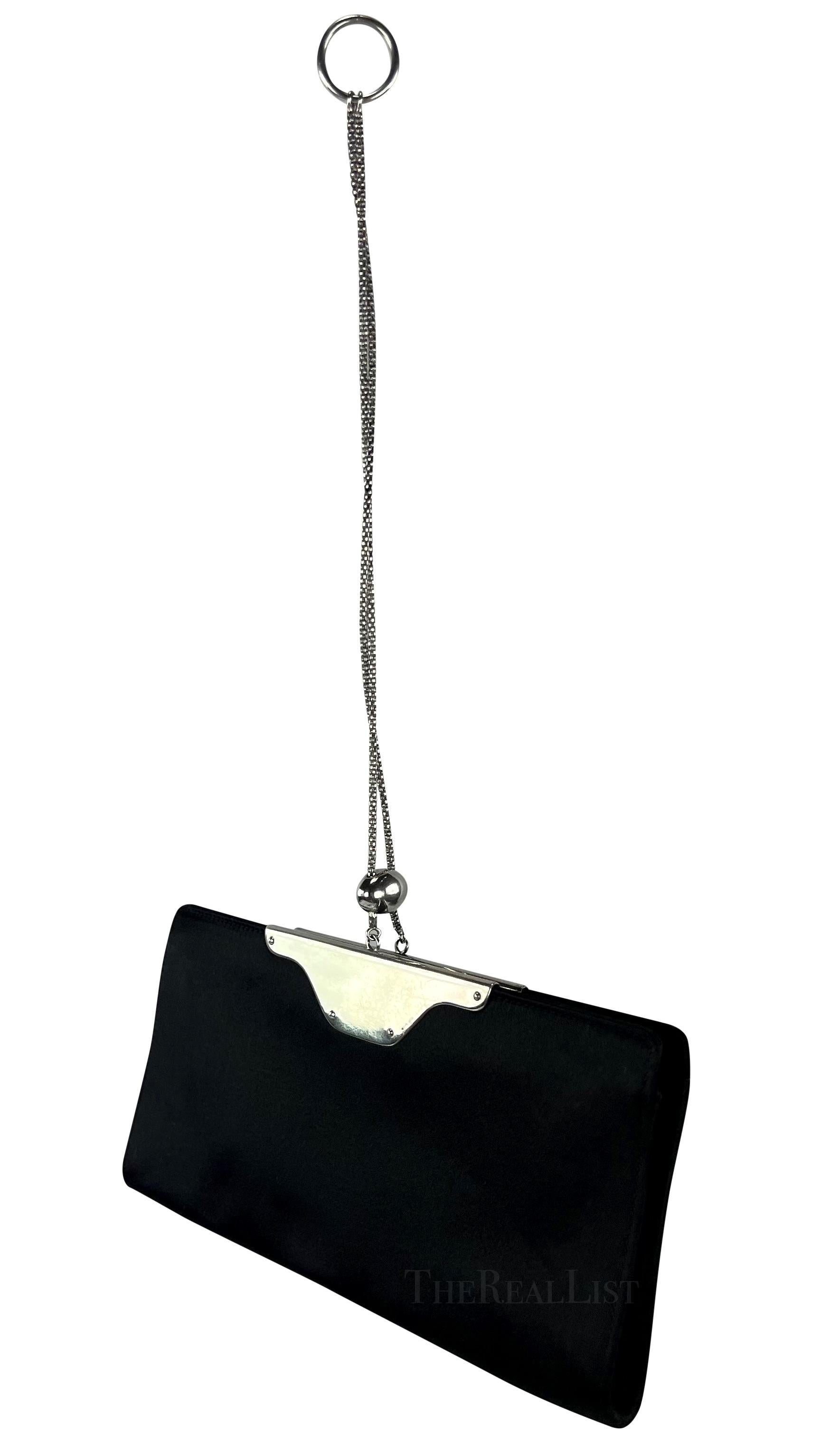 Presenting a fabulous black satin Yves Saint Laurent ring chain clutch. Indulge in the exquisite allure of the fabulous black satin Yves Saint Laurent ring chain clutch, a true fashion statement from the mid-late 2000s. Crafted with meticulous