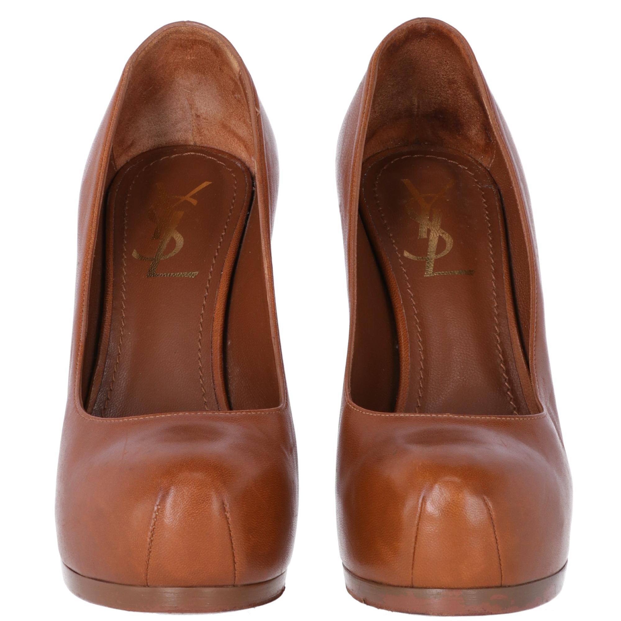 Yves Saint Laurent genuine brown leather fashionable Tribtoo pumps with almond point and two seams. Stiletto heel, outer thin platform and inner invisible platform.  Brown genuine leather insole and gold printed logo. Serial number printed
