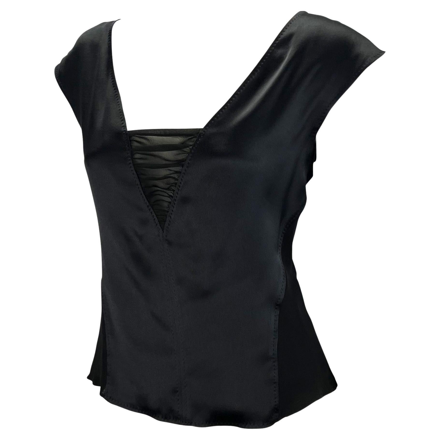 TheRealList presents: a crepe and satin silk panel top designed by Tom Ford in the early 2000s for Yves Saint Laurent Rive Gauche. The body of this top is constructed in sheer silk chiffon with ruching at the bottom of the deep v-shaped neckline.