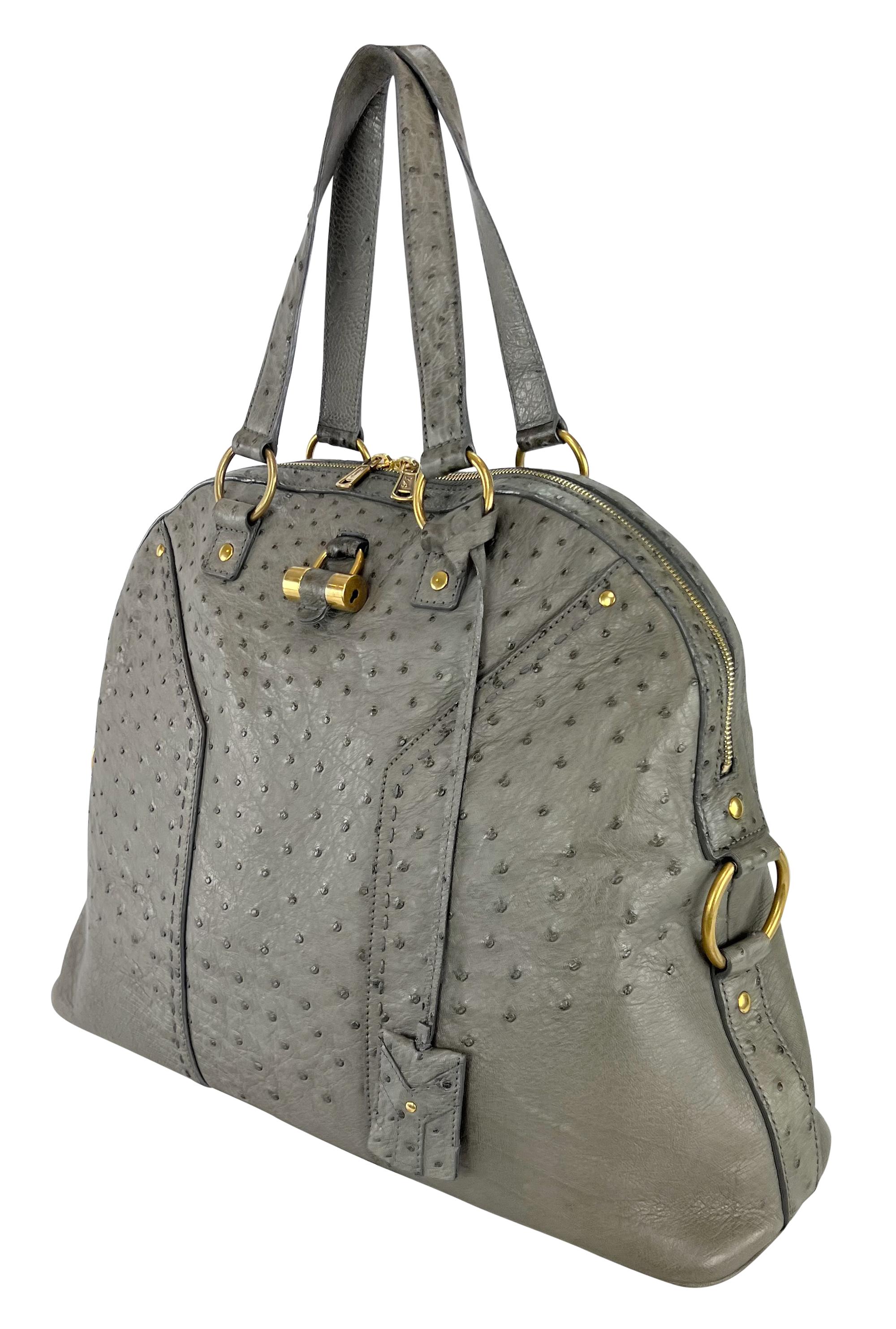 From the late 2000s, this gorgeous, grey Yves Saint Laurent 'Muse' bag is constructed entirely of genuine ostrich leather. Designed by Stefano Pilati, this oversized bag features a dome shape and is complete with gold-tone hardware. The perfect
