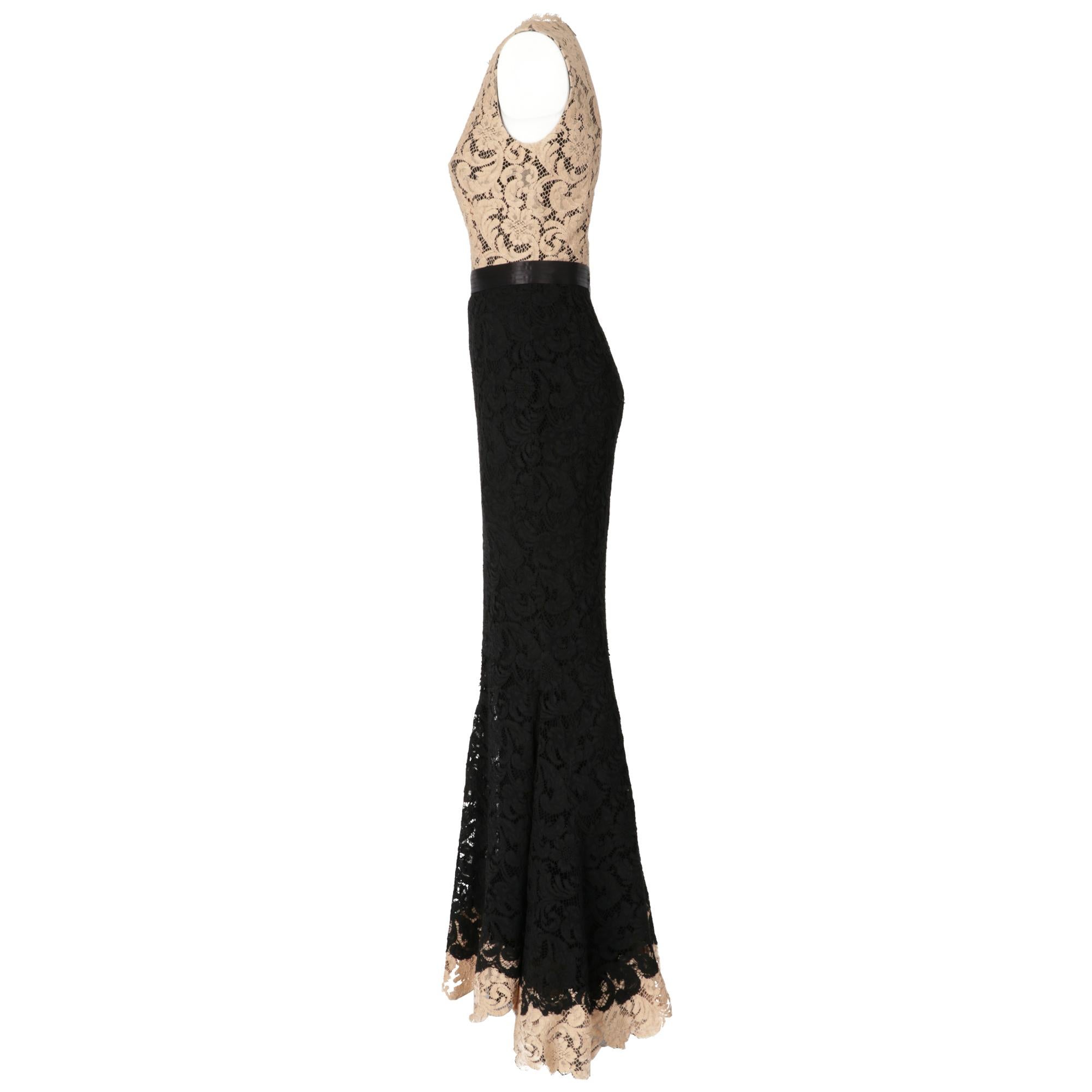 Zuhair Murad mermaid sleeveless dress with beige lace bust and bottom band, black lace skirt, black satin waist band, silk lining and tulle flounce in the bottom skirt.
Years: 2000s

Made in Italy

Size: 38 IT

Linear measures

Height: 162 cm 
Bust: