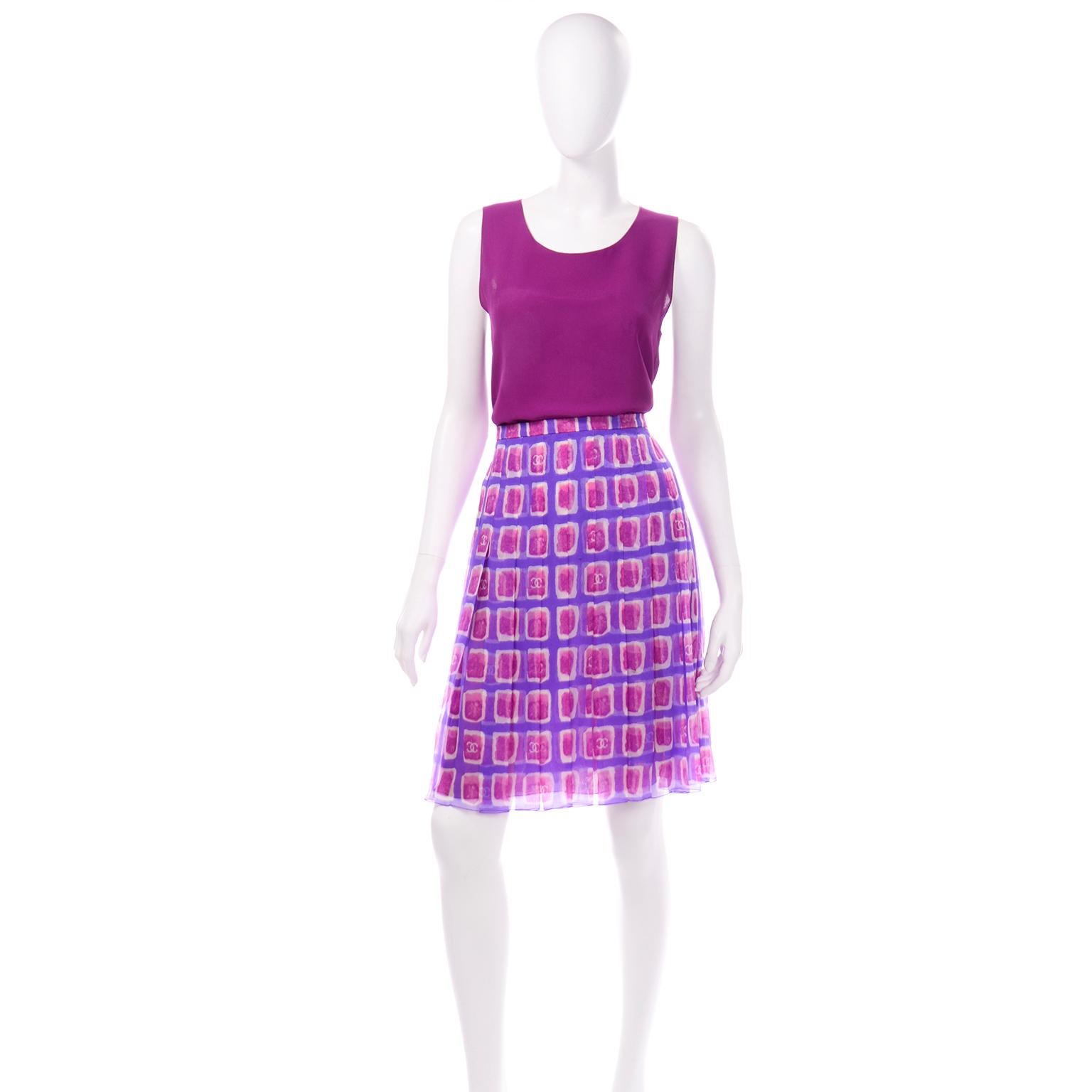 This is a such a lovely vintage S/S 2001 Chanel purple silk tank top and printed silk pleated skirt ensemble. The tank style sleeveless top of this set is a in a beautiful double layered raspberry or magenta silk. There are 2