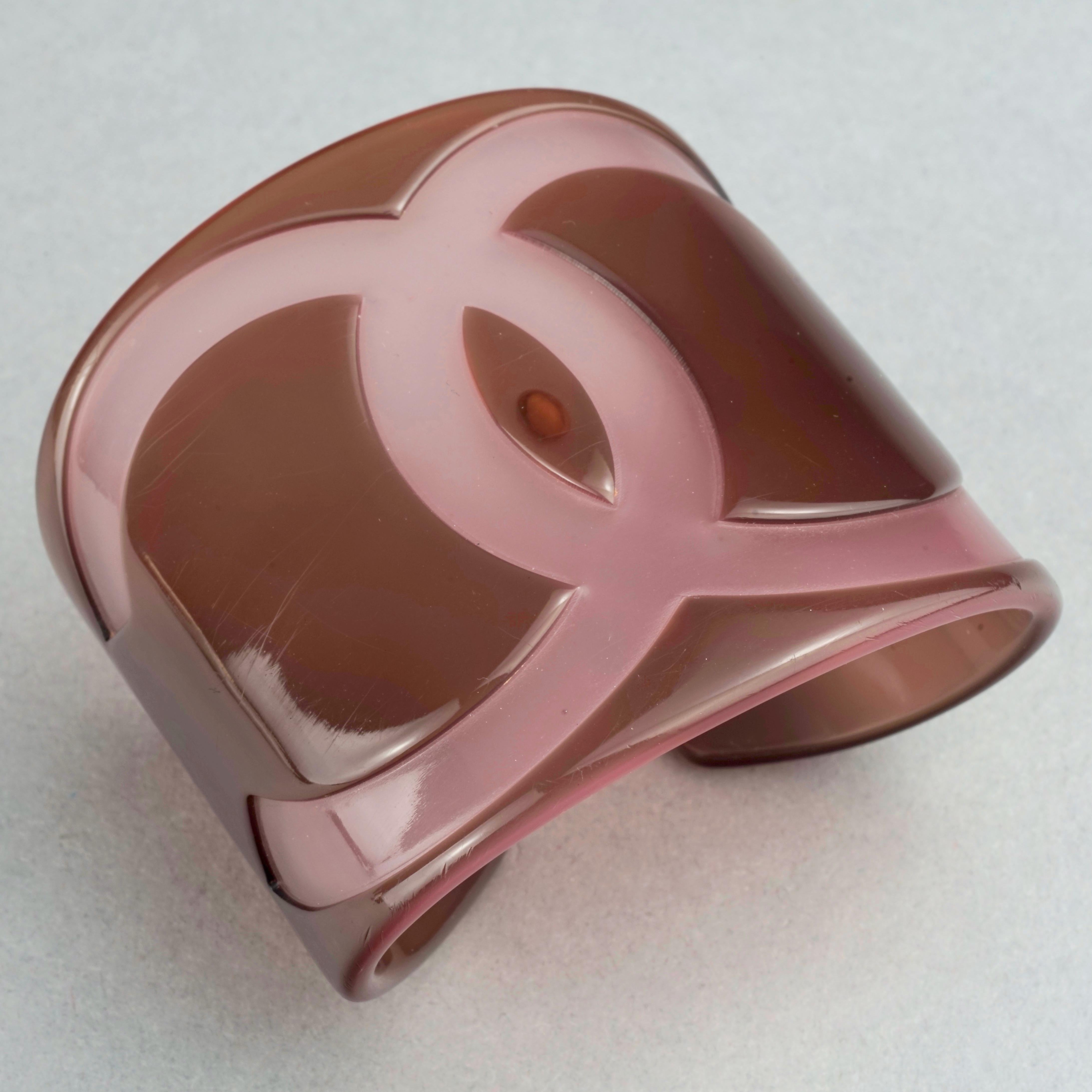 2001 CHANEL CC Logo Perspex Wide Cuff Bracelet	

Measurements:
Height: 2.16 inches (5.5 cm)
Circumference: 5.71 inches (14.5 cm) including normal opening
Opening: 0.6 inch to 0.75 inch (1.5 cm to 1.9 cm)
Inner Diameter: 2.16 inches X 1.50 inches