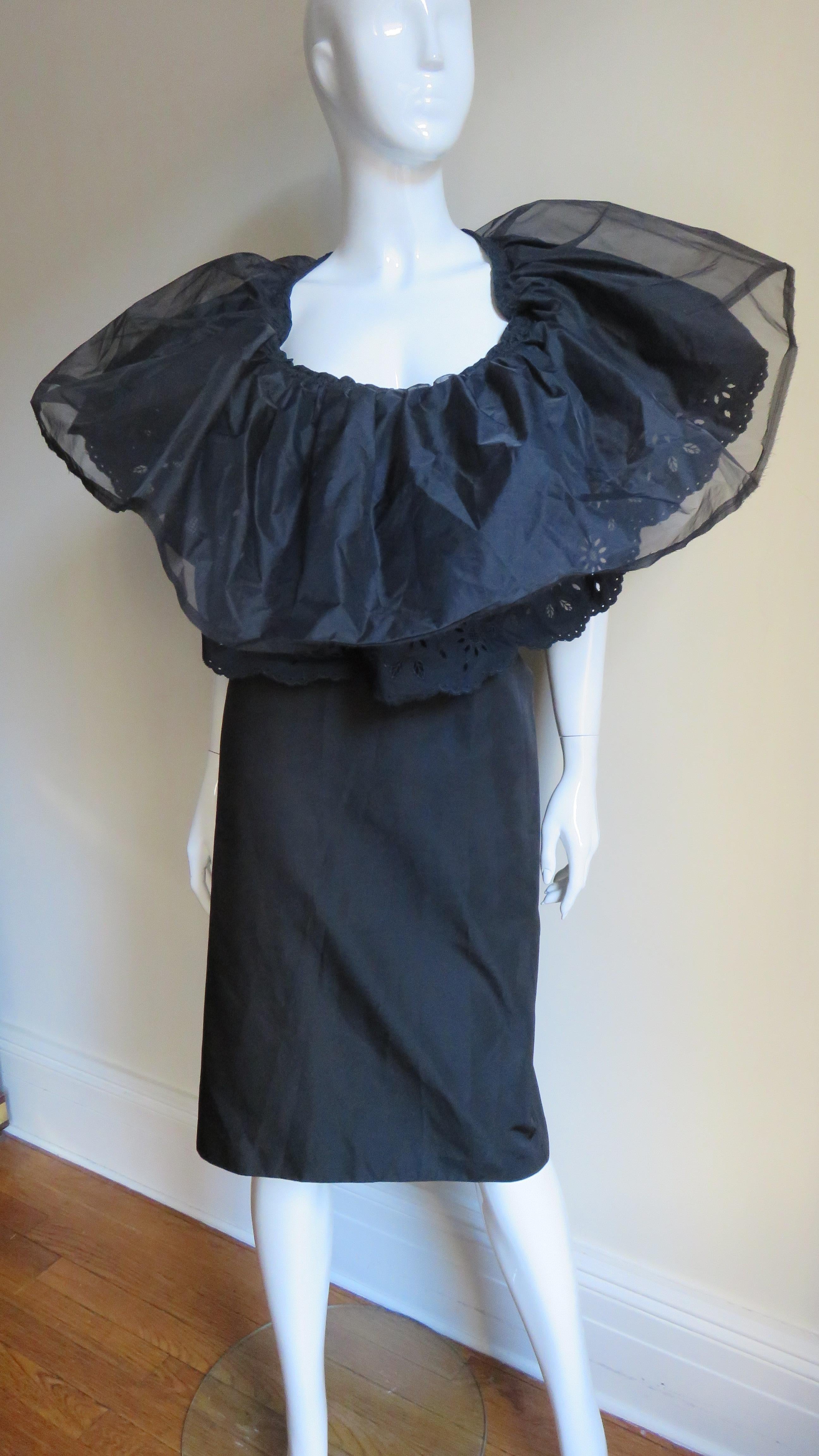 A fabulous black sheath dress with a large collar from the Comme des Garcons AD 2001, CDG collection.  The front has a deep scooped neckline with a large double ruffle collar- the top layer organza and underneath is eyelet lace.  The dress has a