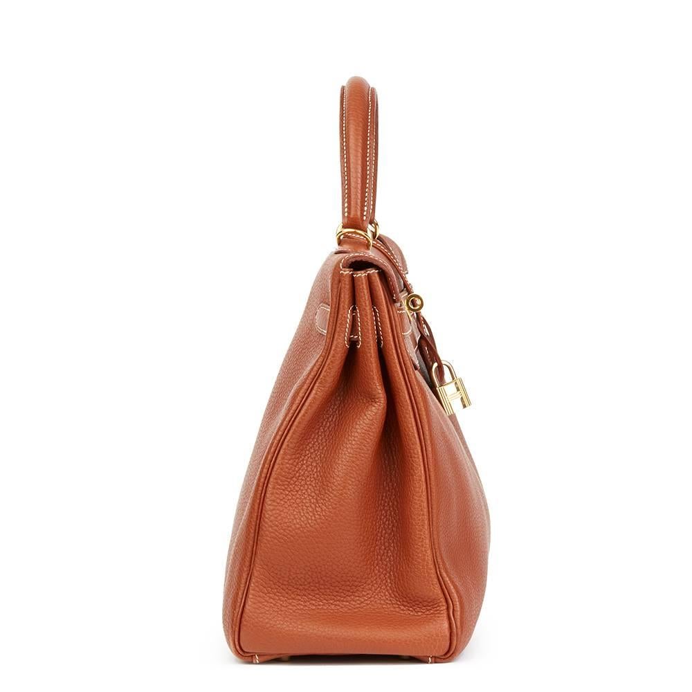 HERMÈS
Brique Togo Leather Kelly 32cm Retourne

This HERMÈS Kelly 32cm is in Good Pre-Owned Condition accompanied by Hermès Dust Bag, Lock, Keys, Clochette, Shoulder Strap. Circa 2001. Primarily made from Togo Leather complimented by Gold hardware.