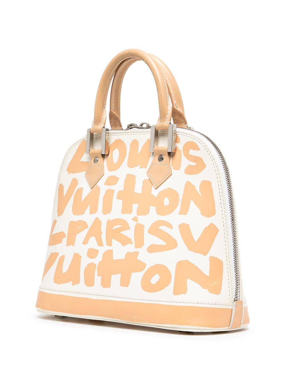 A must-have for any Louis Vuitton lover, this pre-owned Alma bag from the limited-edition 2001 collaboration of artist Stephen Sprouse and Louis Vuitton. This iconic design has been artistically crafted in white matte leather with a beige graffiti