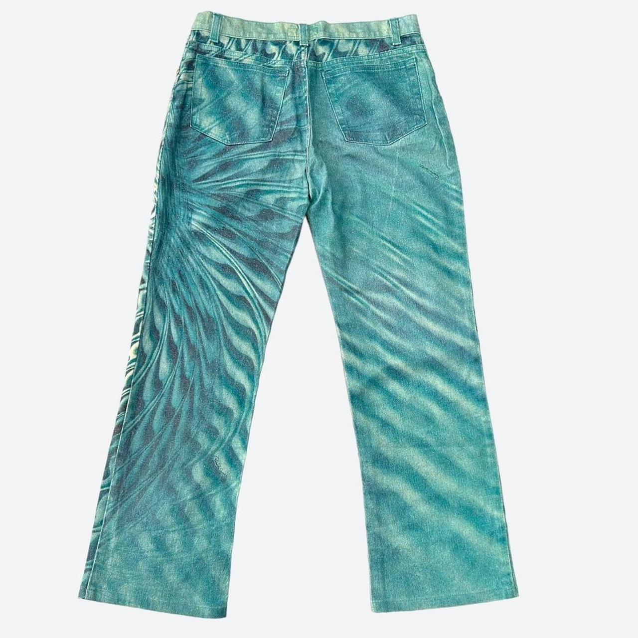 The uniquely hypnotic and somewhat aquatic feel of these teal blue pants instantly transports one back to the beginning of the millennium, brilliantly encapsulating the playful, energetic and cyber centered aesthetic of the time.

The 2% elastane to
