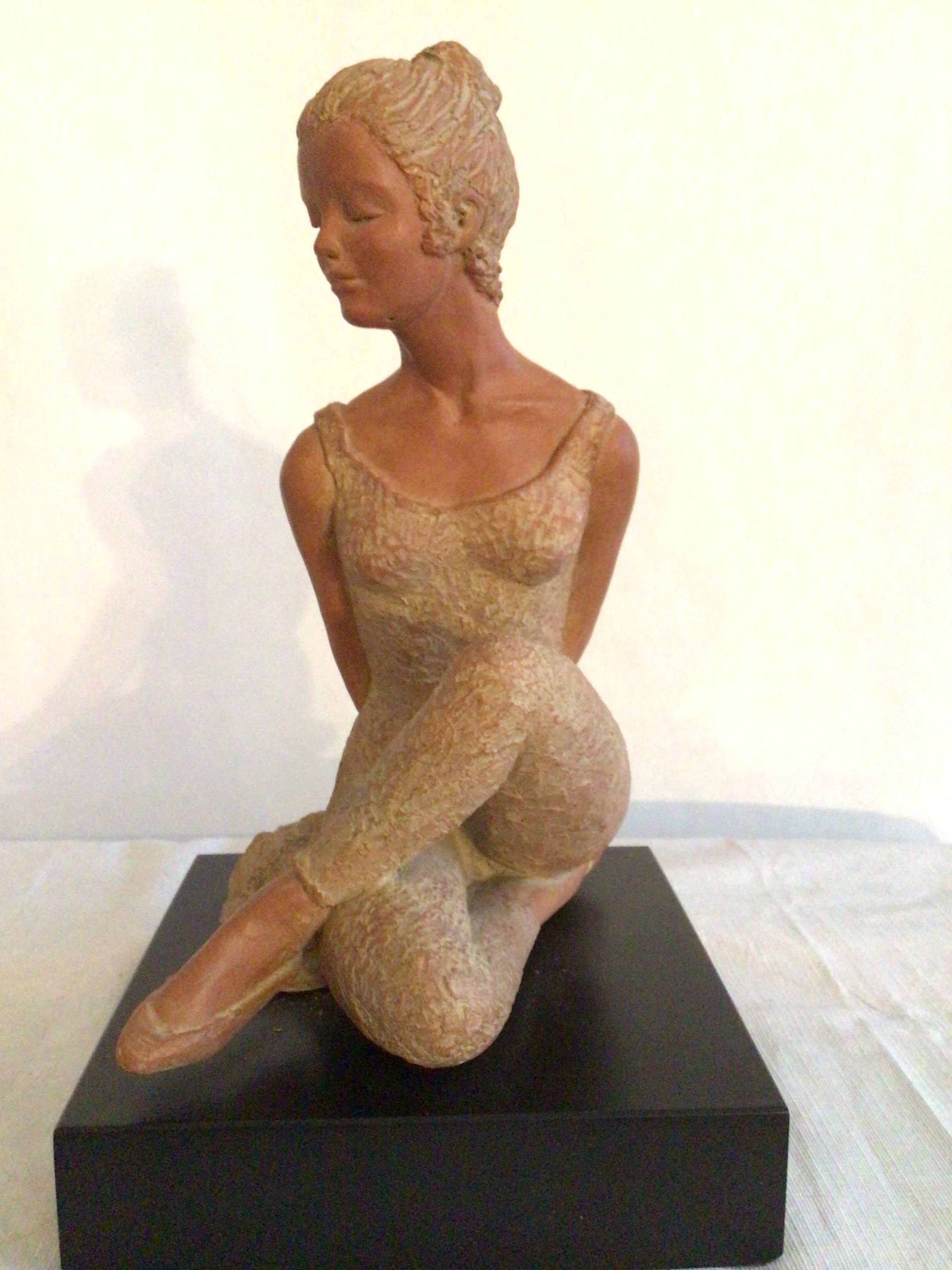 2001 Terracotta Sculpture On Wood Base Of A Ballerina Dancer Sitting Down With Her Legs Crossed
Yoga pose/ stretch
Stamped: AMR
On a black painted wood base
Texture in leotard and leggings
Small hole under chin where mounted (not shown)