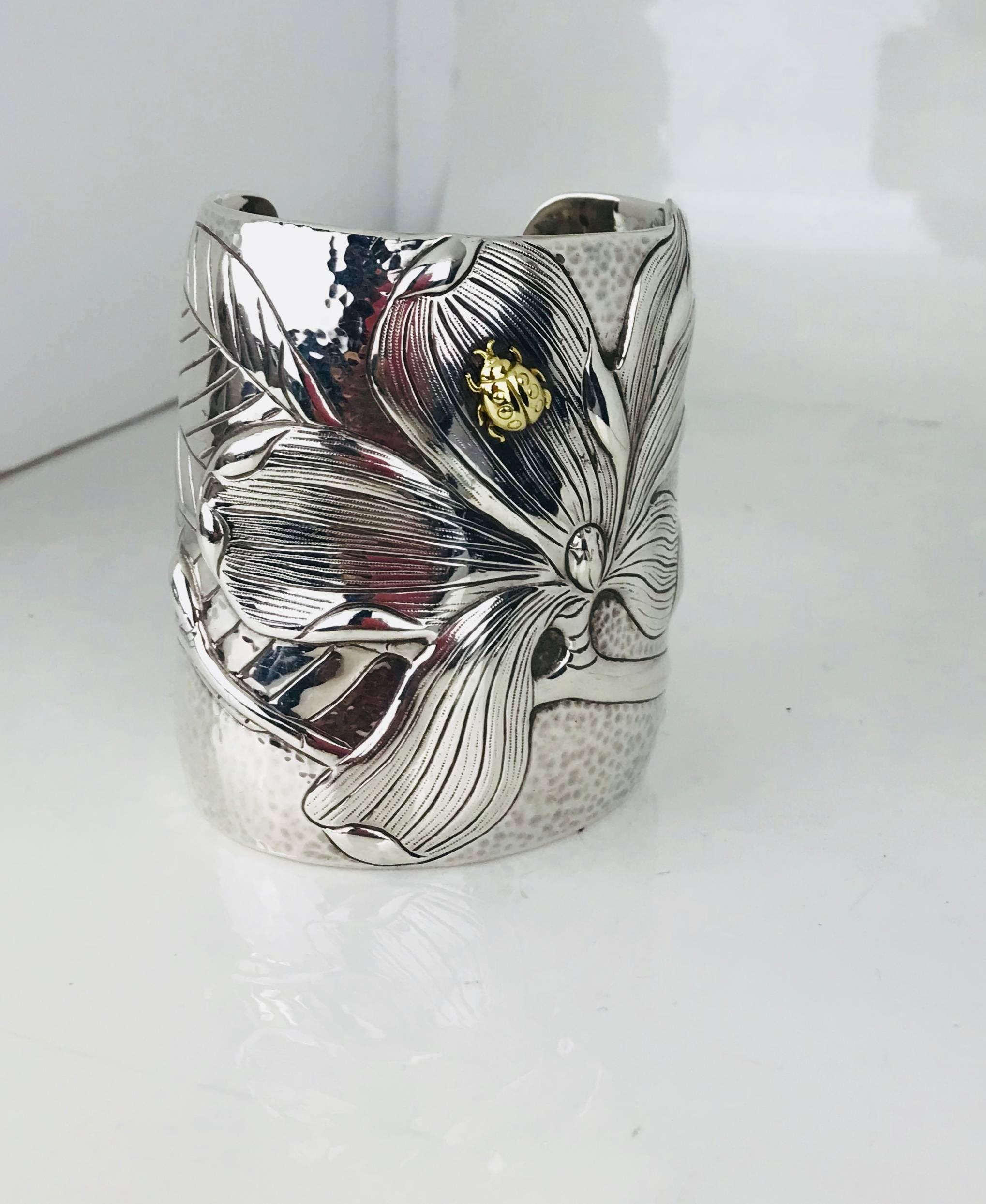 2001 Tiffany & Co. 925 750 Hand Hammered Magnolia Lady Bug Cuff Bracelet
Vintage, Retired, & Extremely Rare

Sterling Silver Repousse with Applied 18k Lady Bug.

Heavy Repousse Magnolia Flower with Deeply Veined Leaves Plus a Single Yellow Gold Lady
