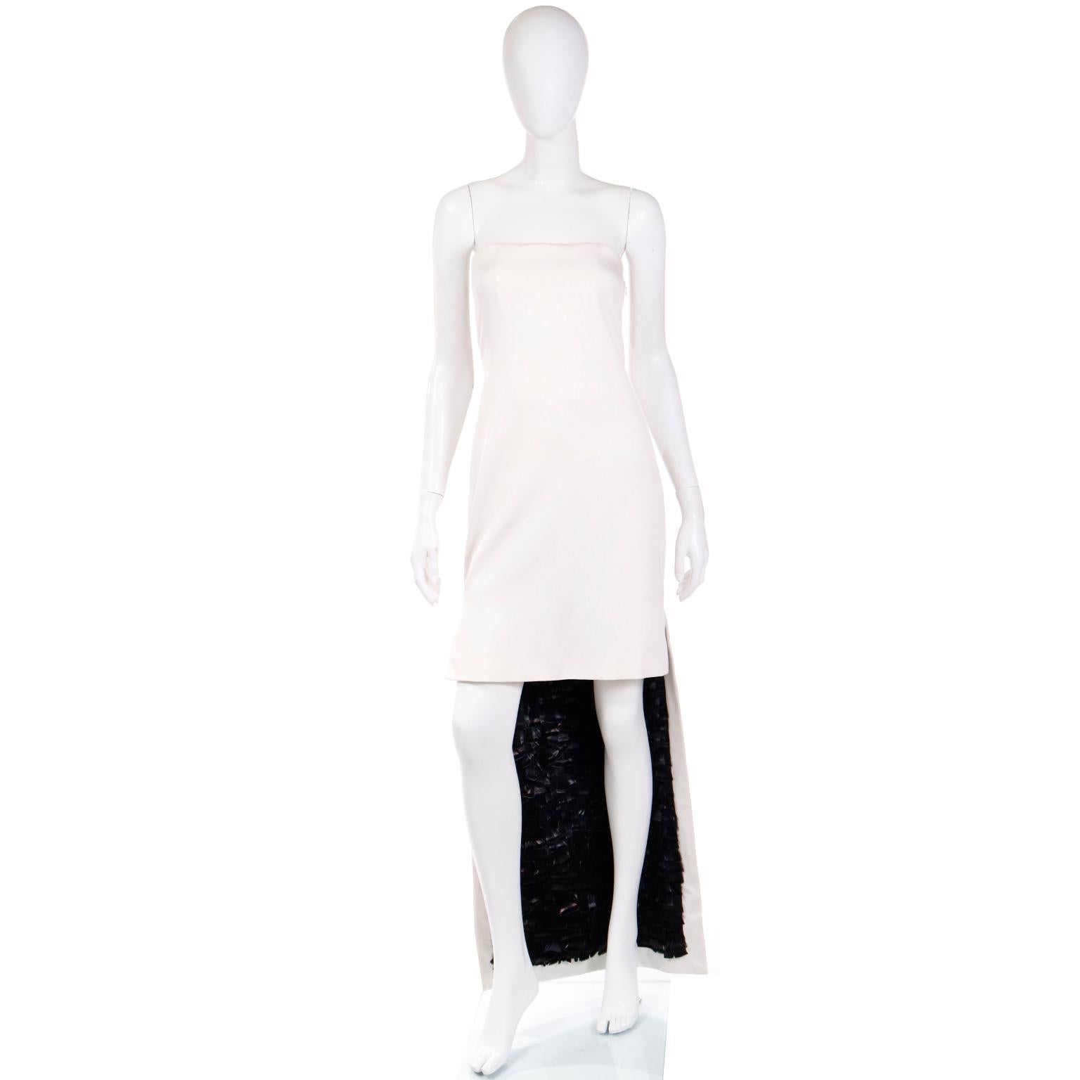 This is a stunning vintage Yves Saint Laurent ivory silk strapless evening dress designed by Tom Ford for the Spring/Summer 2001 YSL Rive Gauche collection. This incredible dress has a unique high-low style, fitting above the knee in front, with a