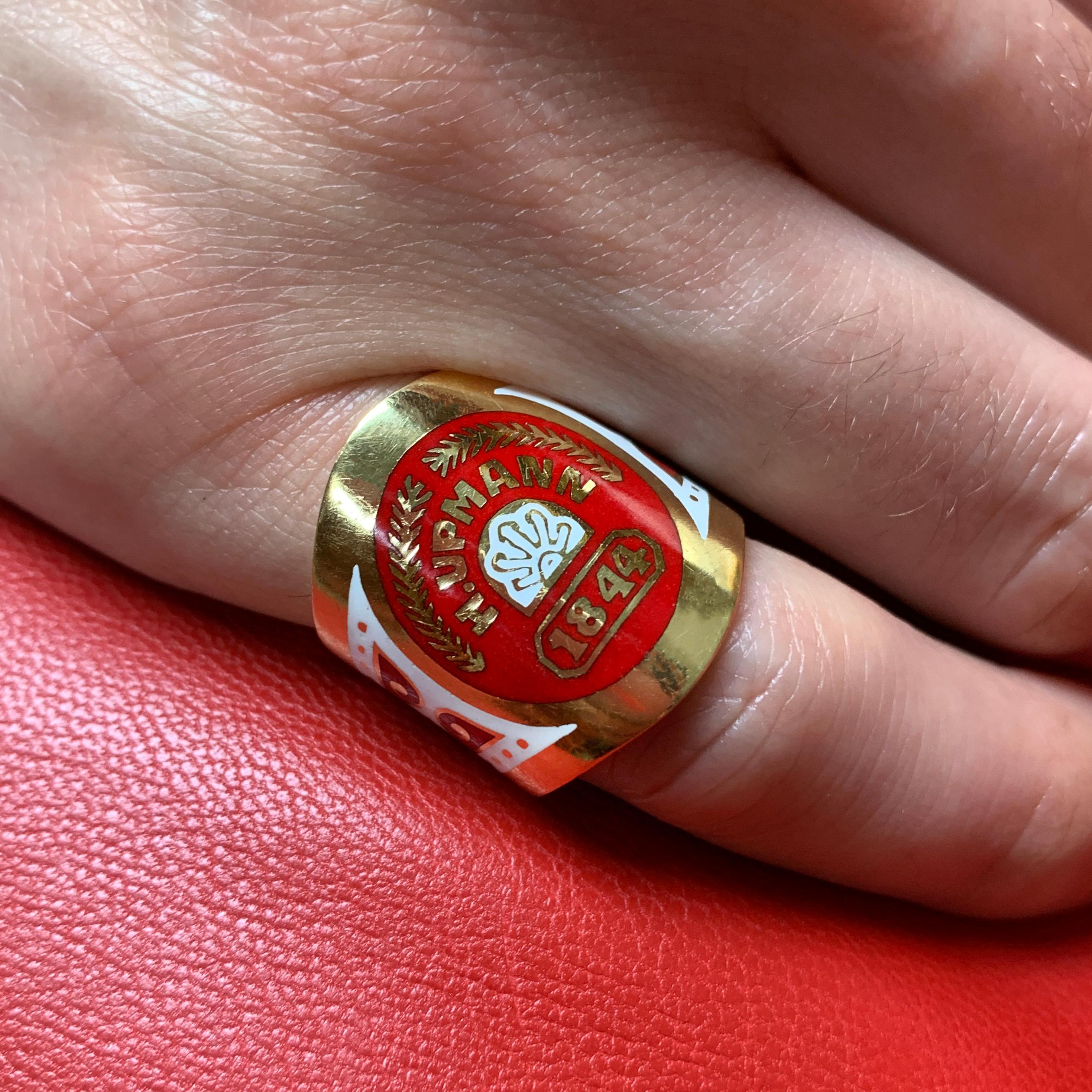 An enamel and 18 karat gold cigar band ring, by Verdura, 2001. 

The ring is a size 5 and is signed Verdura, maker's mark and French import mark.