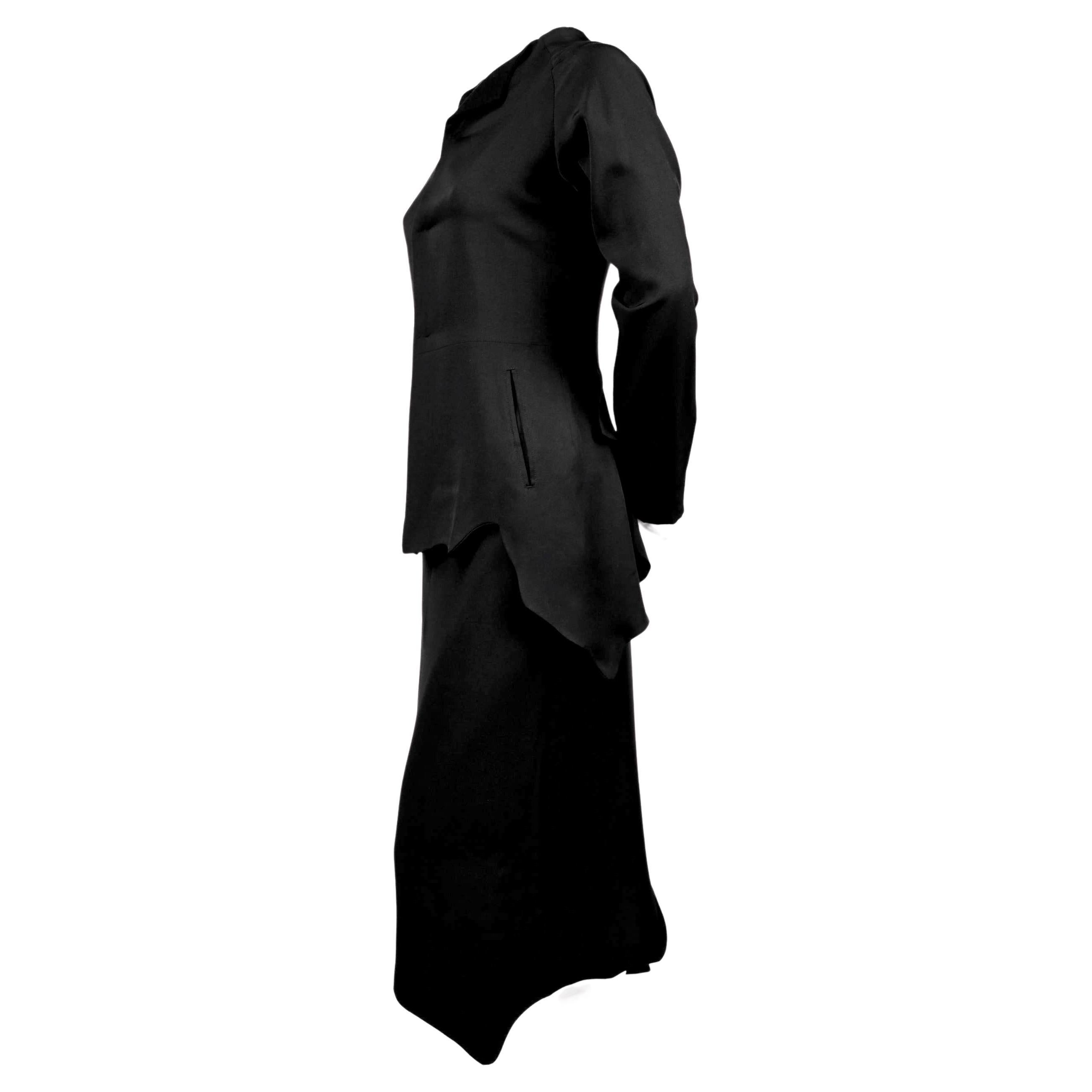 Jet-black, asymmetrical, silk jacket and skirt from Yohji Yamamoto exactly as seen on the runway for fall of 2000. Size '1'. Fits a US 2. Approximate measurements: Jacket: bust 32