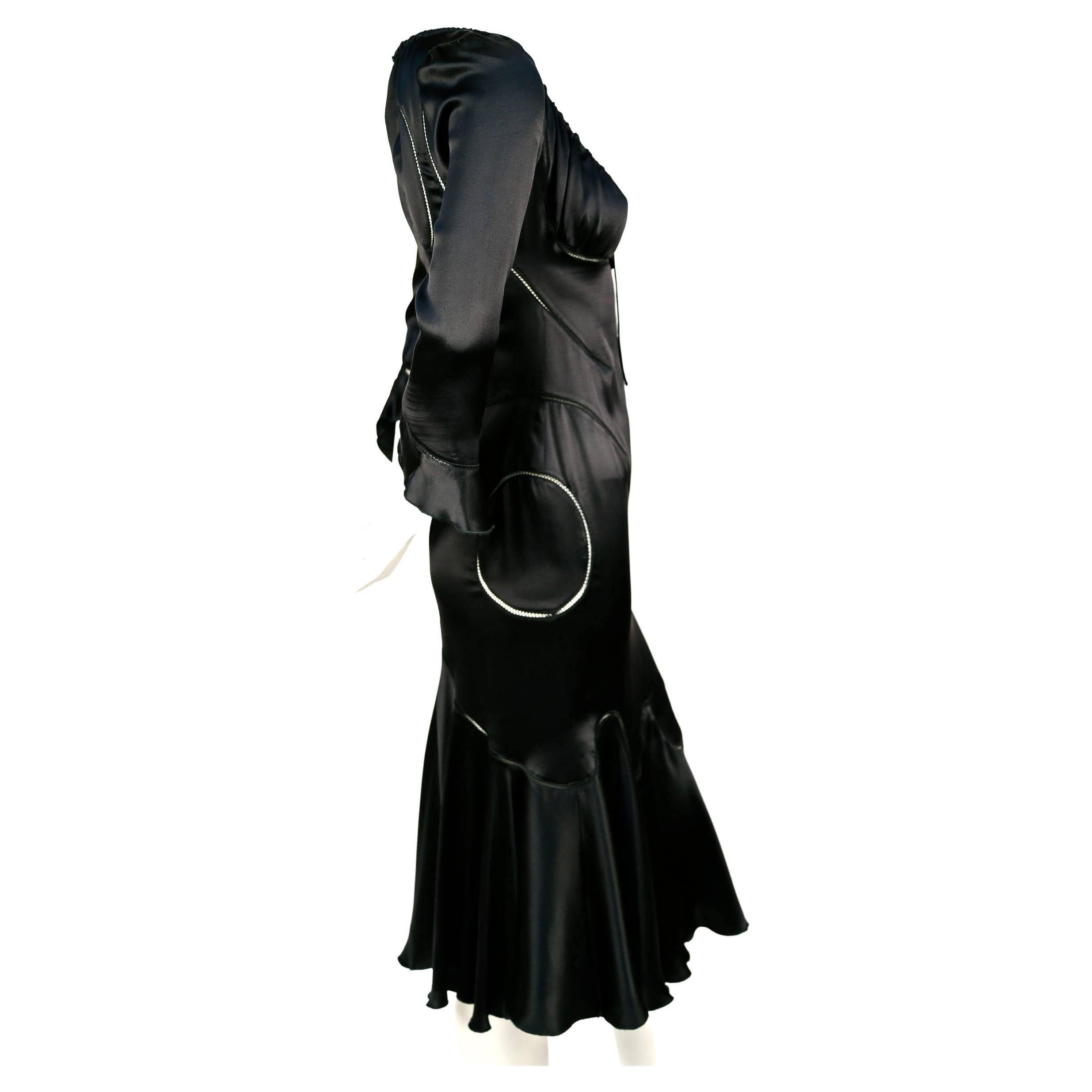 Very rare jet black silk charmeuse dress with open stitched seaming created by Alexander McQueen for the Fall 2002 'Supercalifragilisticexpialidocious' runway collection. No size is indicated although this dress best fits a size 2 or 4. Approximate