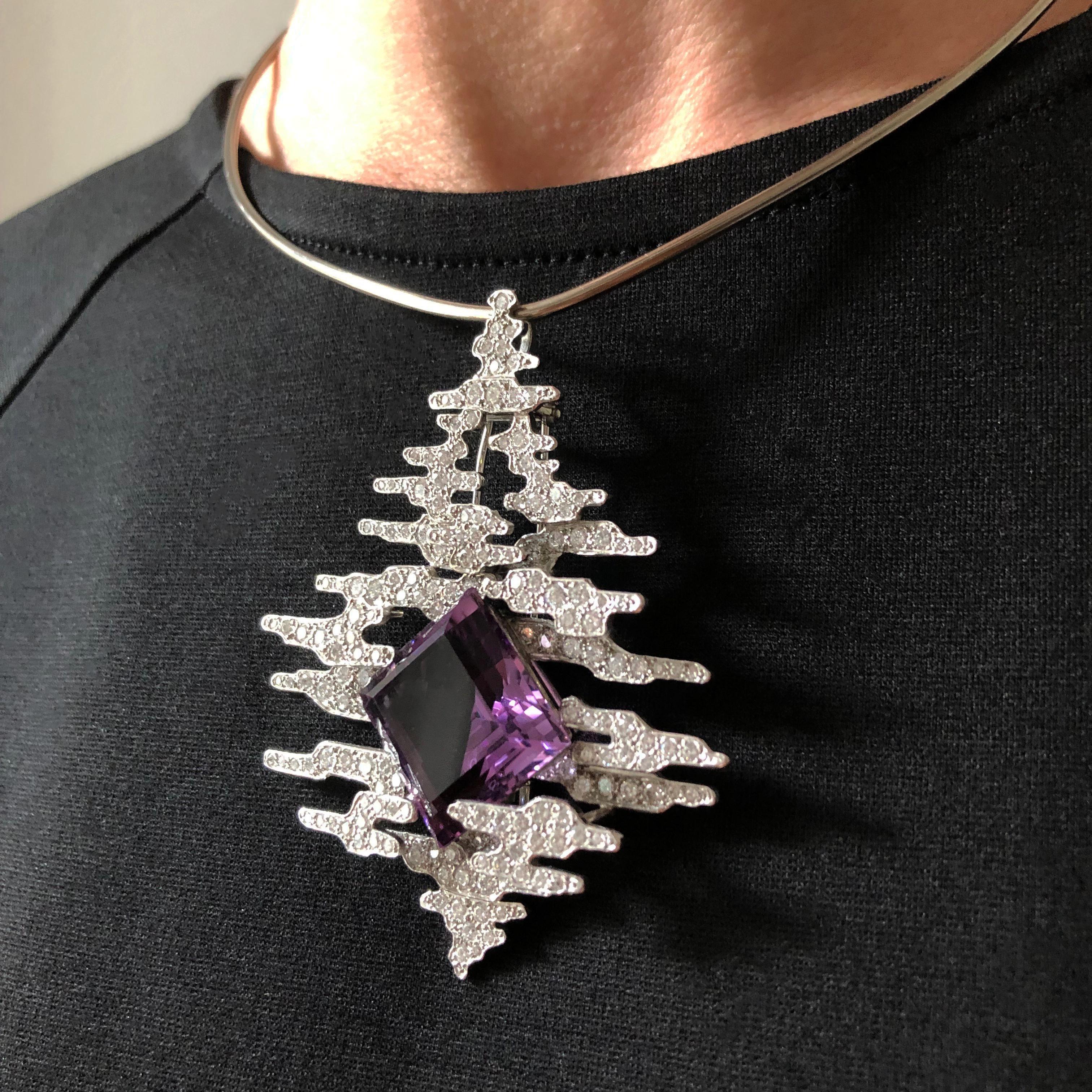 A square cut amethyst, pavé-set diamond, and 18 karat white gold pendant, on an 18 karat white gold torque, by Andrew Grima, made in 2002. The amethyst weighs approximately 35.00 carats, and the diamonds weigh approximately 5.30 carats.

The pendant