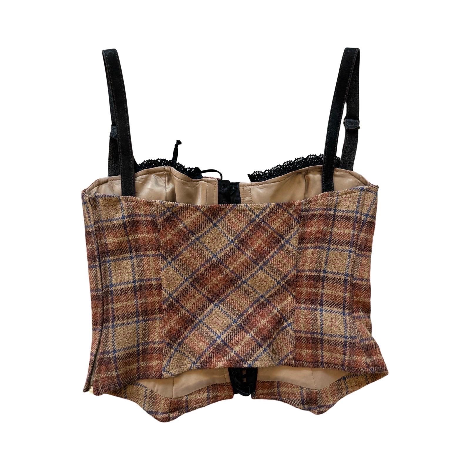 From the D&G Dolce&Gabbana Autumn/Winter 2002 runway, is this gorgeous tartan wool corset top.  It is done in a browns and blue colors with black lace up detailing and brown leather straps. The bustier has cups, boning, lace up front, adjustable