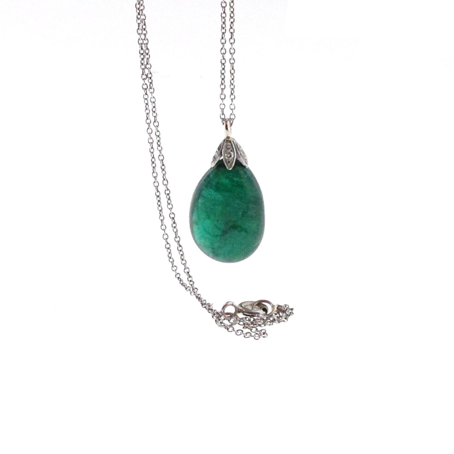 Over 20 carats!!! This natural green emerald pear shape drop is a gorgeous necklace. Set to hang in such a way that it moves with you, this is an extremely elegant necklace. Above the emerald drop is a diamond basket consisting of .12 carats. The