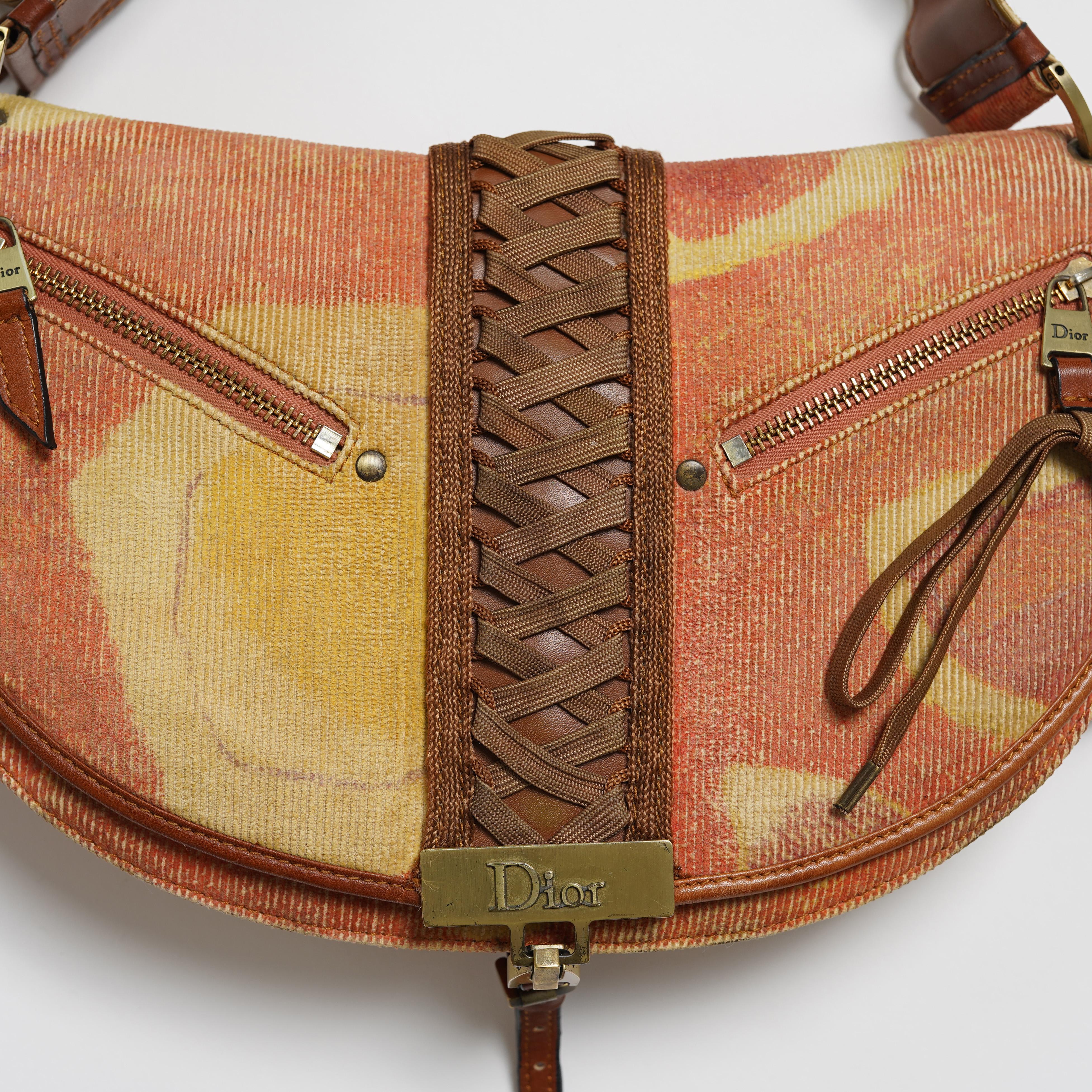 Presenting a collectable 2002 Christian Dior by John Galliano ADMIT IT jacquard corduroy corset hobo handbag featuring lace up detail, bronze tone hardware with Dior logo, front zipper detail, signature Diorissimo monogram canvas lining with three