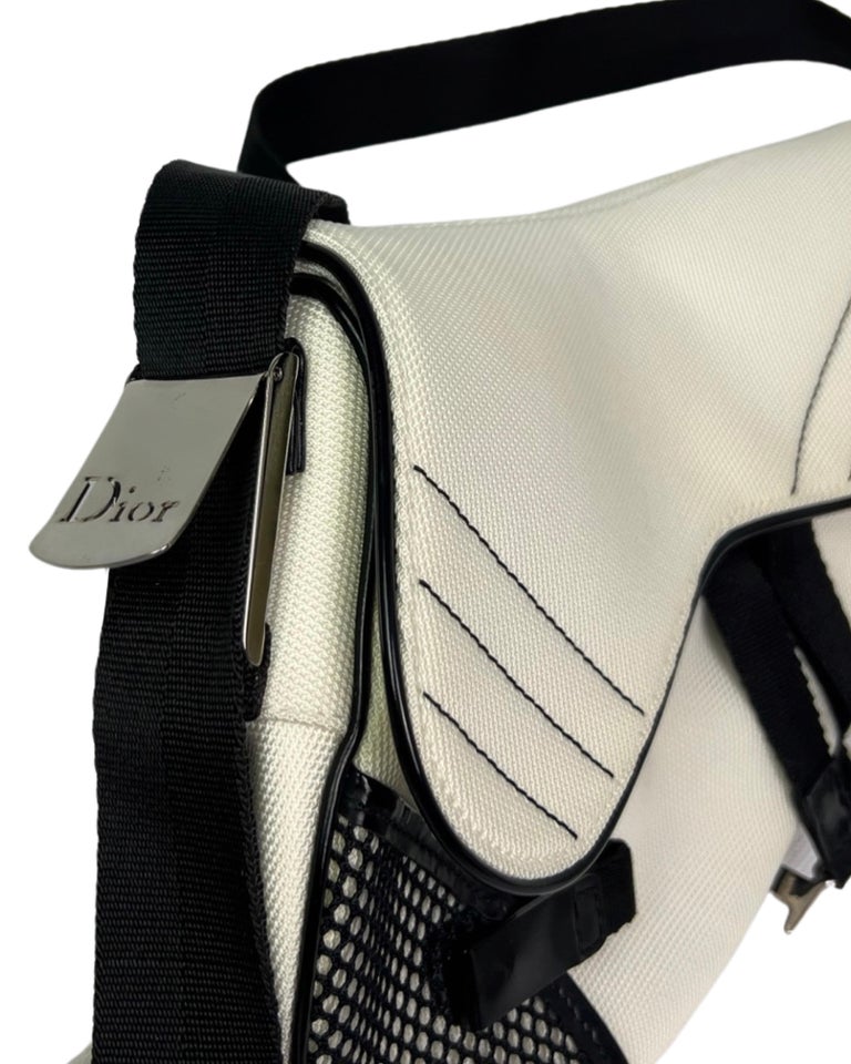 Rare sports style vintage Dior Saddle Bag from 2002 with an adjustable strap - you can wear it multiple ways- as a crossbody, as a shoulder bag, or even as a bum bag.

Excellent vintage condition with minor, non-obvious signs of age. 

This is a