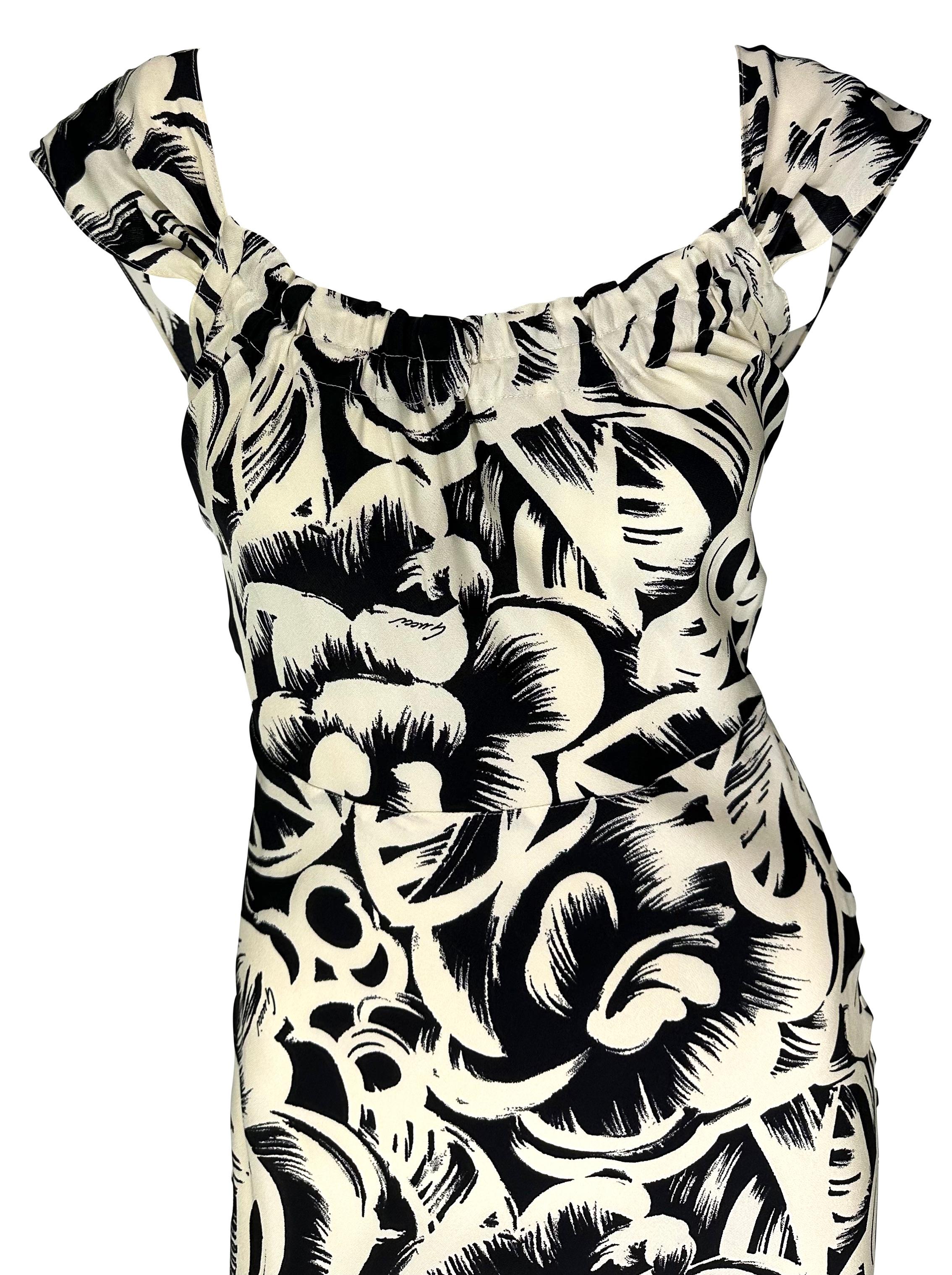 Presenting a beautiful black and white floral Gucci dress, designed by Tom Ford. From 2002, this dress features a wide neckline, off-the-shoulder petal-style sleeves, and is made complete with a semi-exposed back. Add this Gucci by Tom Ford creation