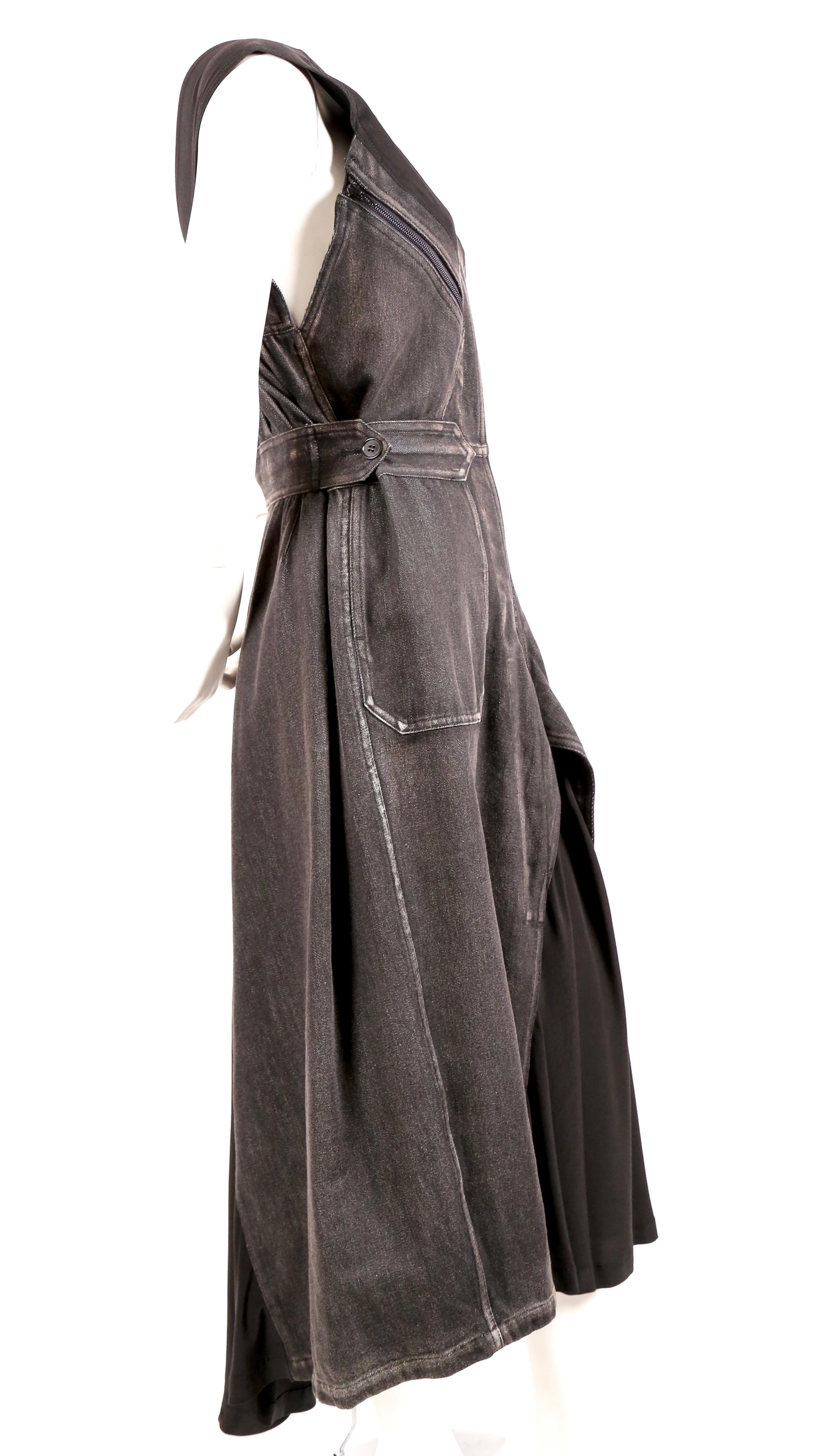 Dramatic, denim dress from Yohji Yamamoto dating to the fall of 2002 exactly as seen on the runway. Made of dark grey/faded black distressed cotton denim with silk/cashmere inserts. Dress can be worn a number of ways. Zips up center front with
