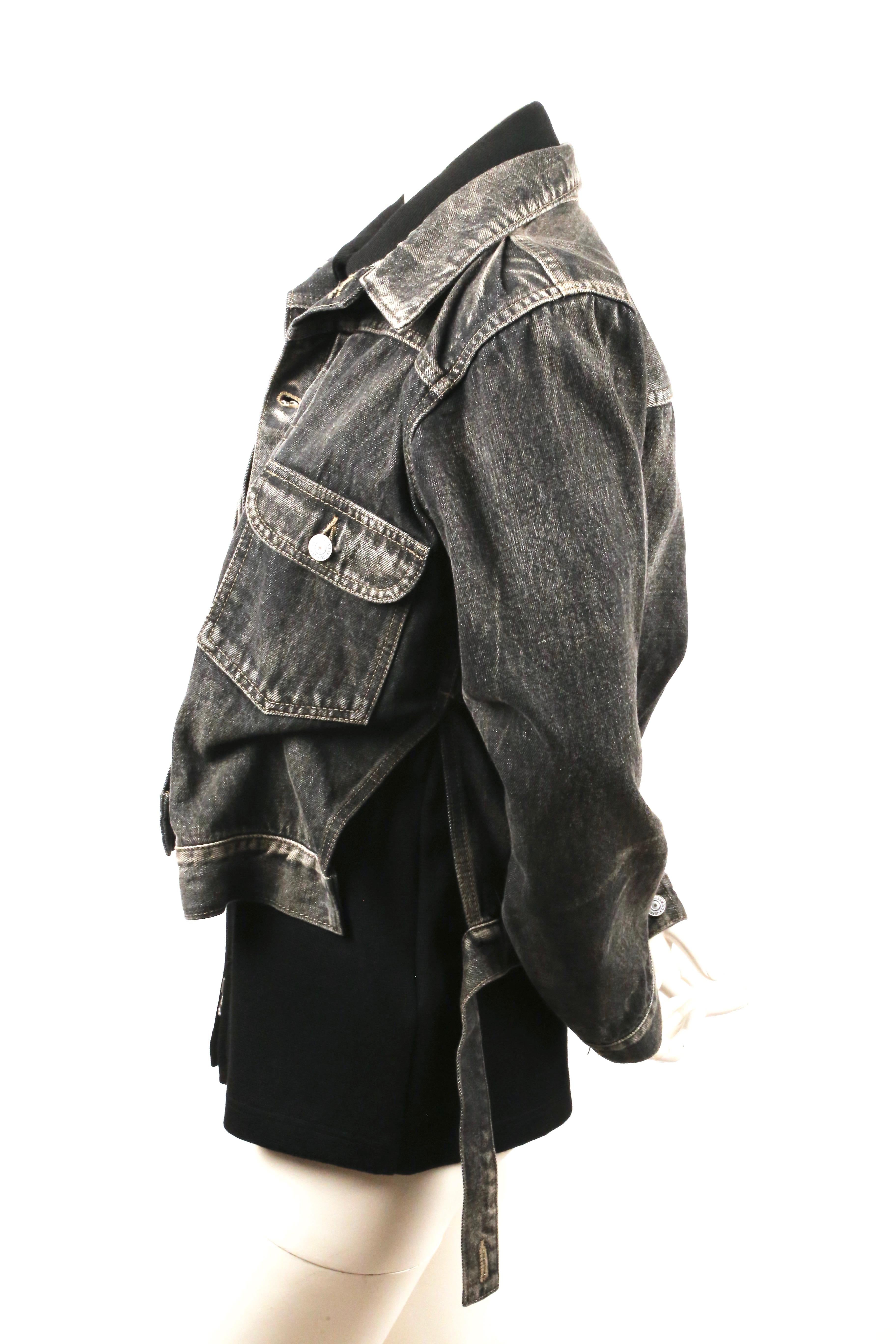 Faded-black, layered, denim jacket from Yohji Yamamoto dating to the fall of 2002 as seen on the runway. Made of dark grey/faded black distressed cotton denim. Under layer of jacket is a black cotton knit and zips up center front with a silver-toned